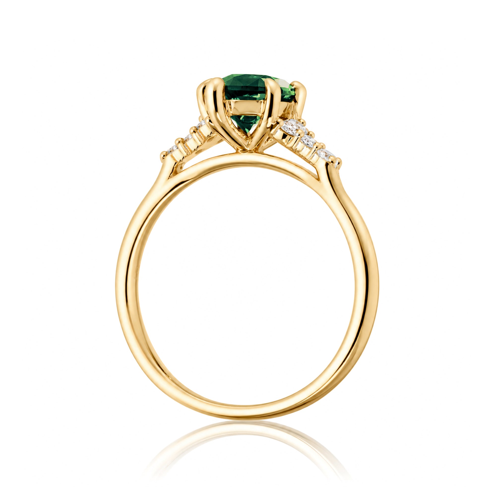 Gold ring with a green gemstone on a white background