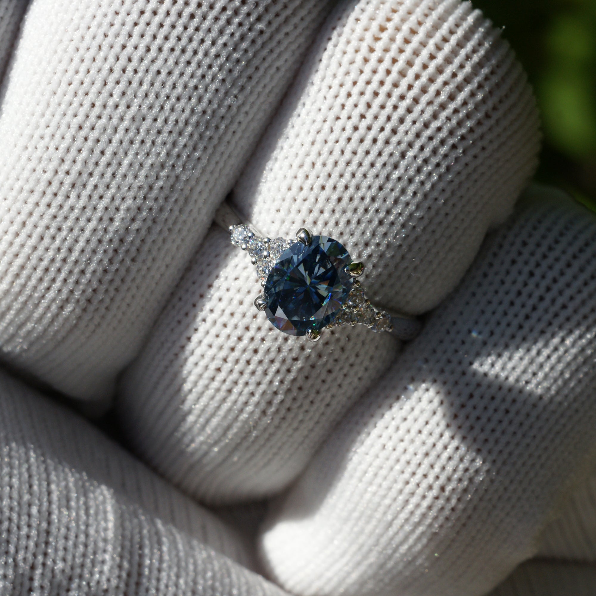Oval grey blue moissanite and diamond three stone engagement ring in white gold