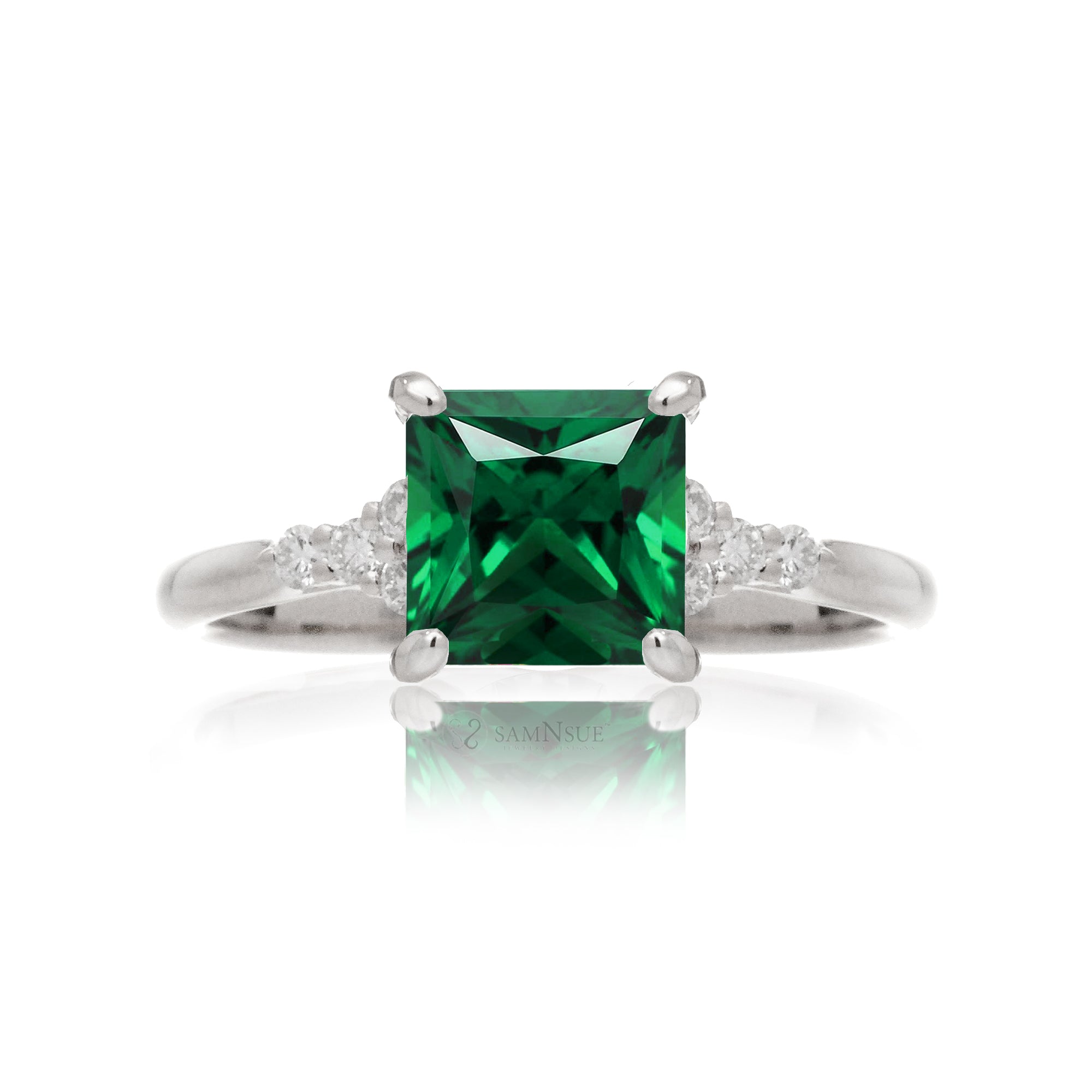 Emerald engagement ring with princess cut and diamond accent in white gold