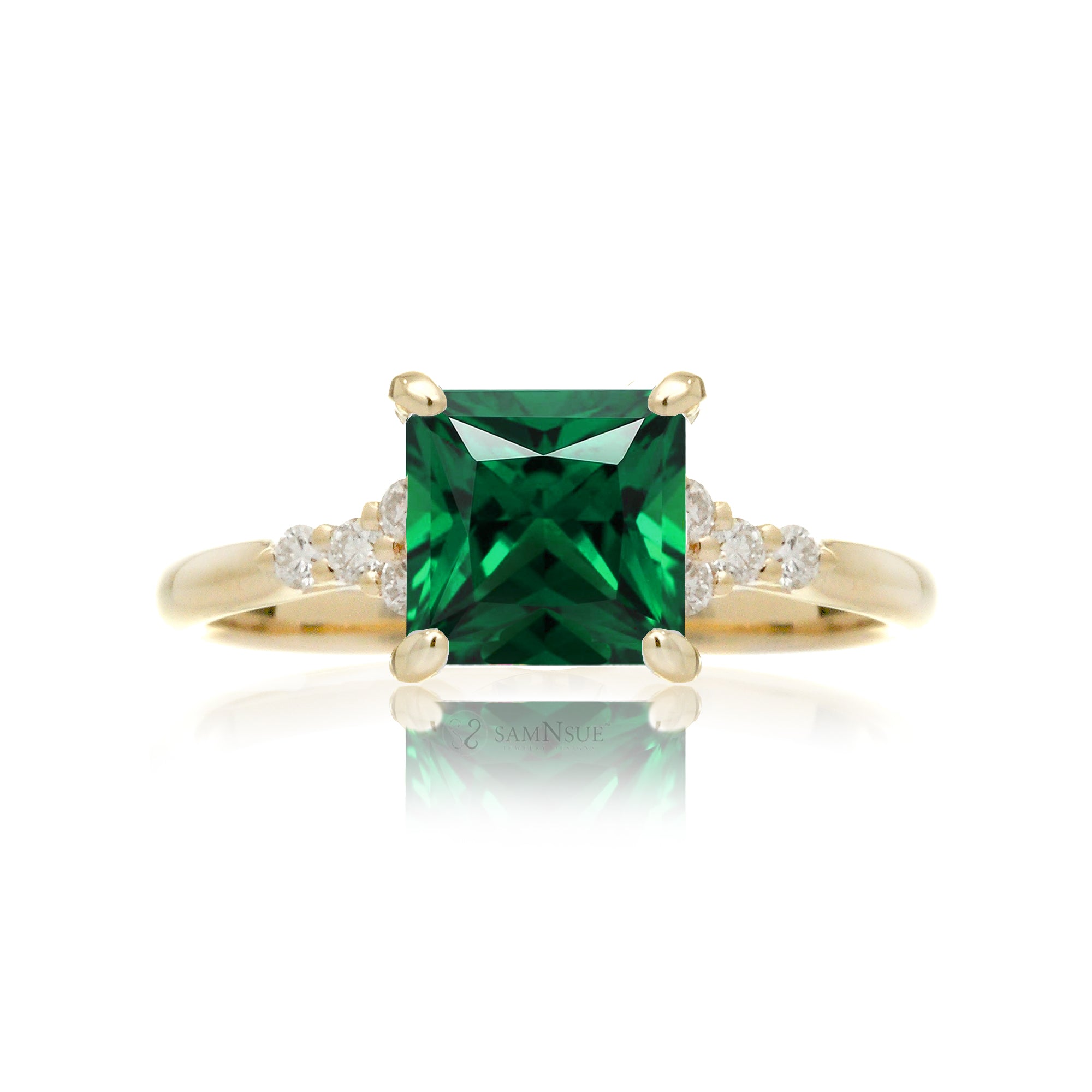 Emerald engagement ring with princess cut and diamond accent in yellow gold