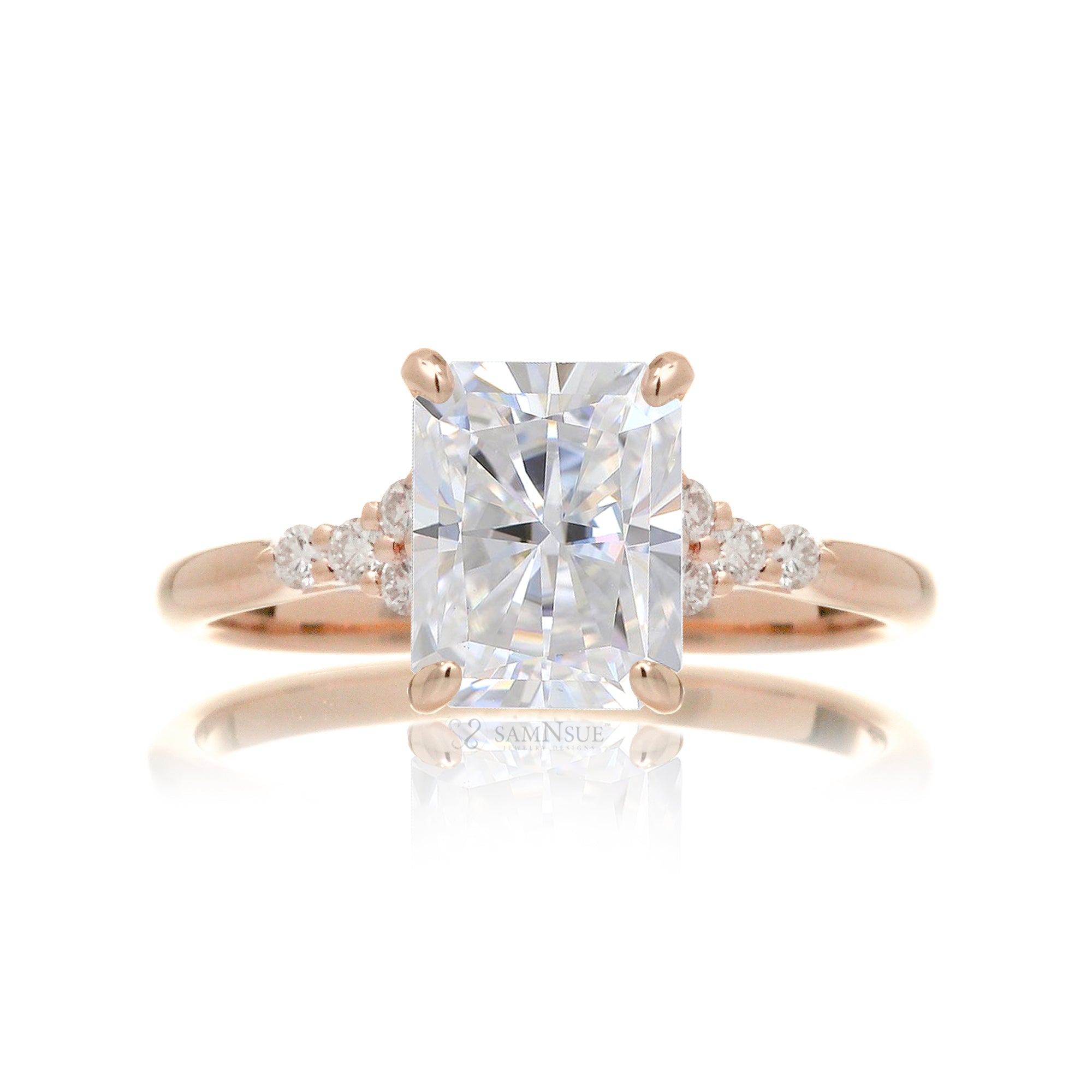 Radiant cut moissanite and diamond three stone ring in rose gold