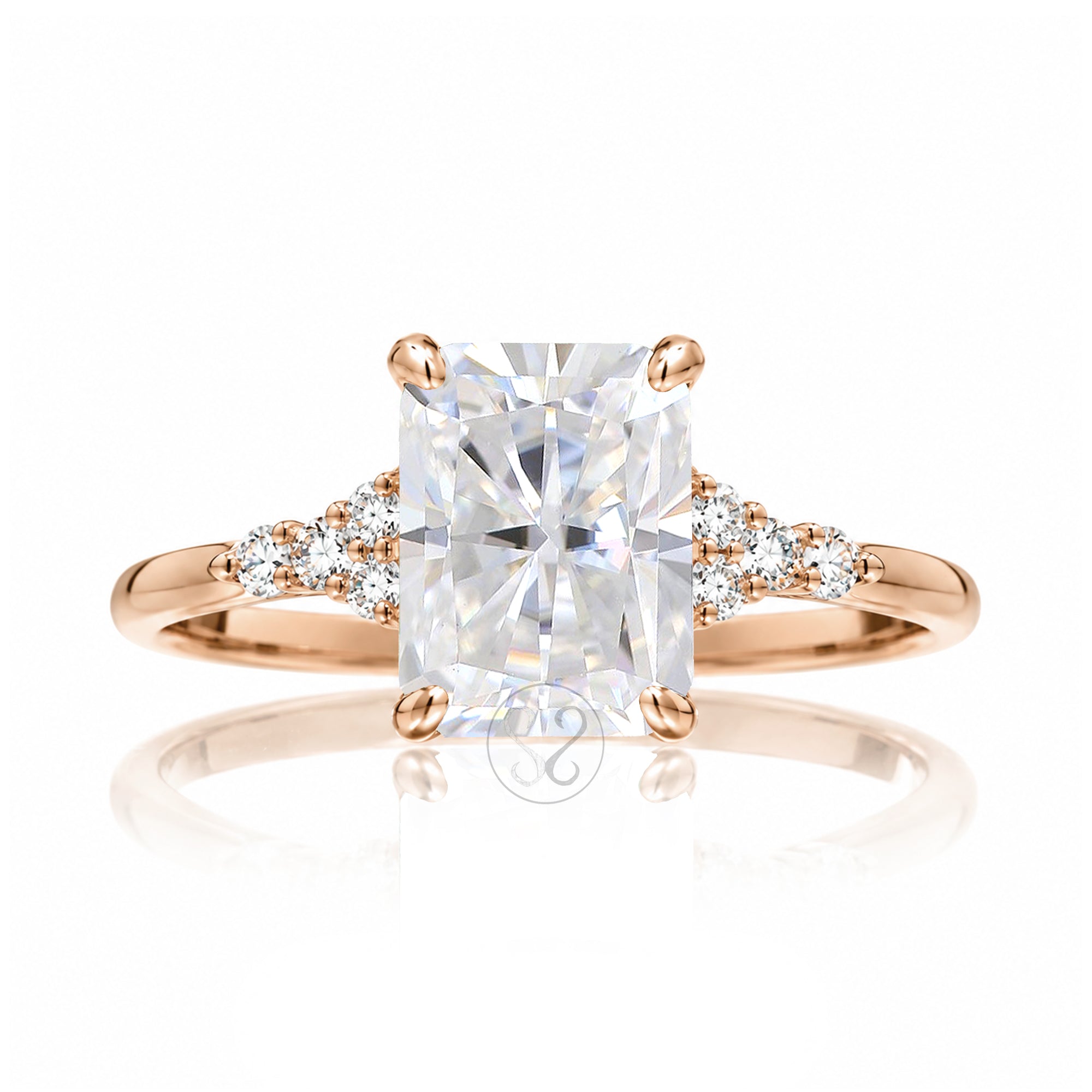 Radiant cut moissanite and diamond three stone ring in rose gold