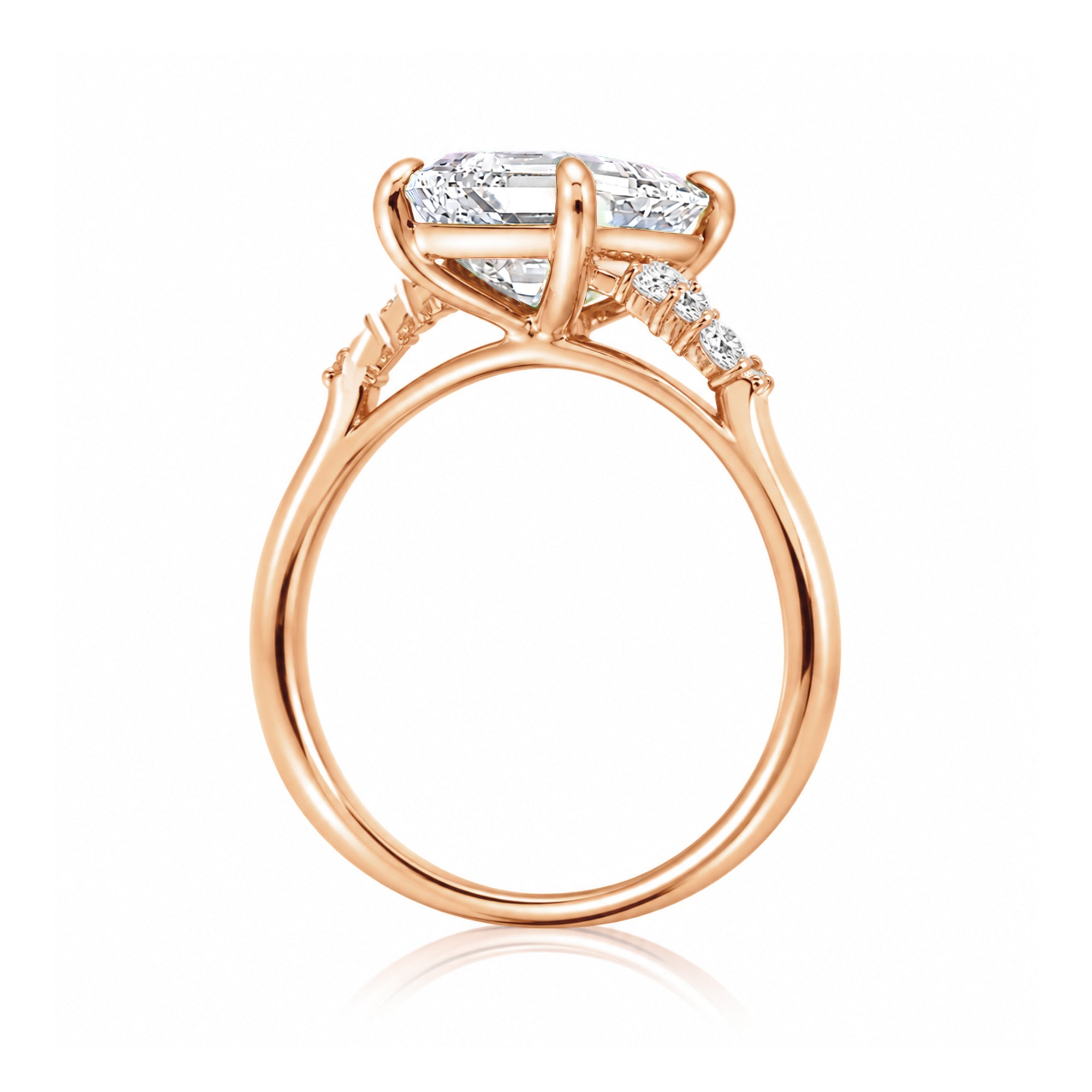 Radiant cut moissanite and diamond three stone ring in rose gold
