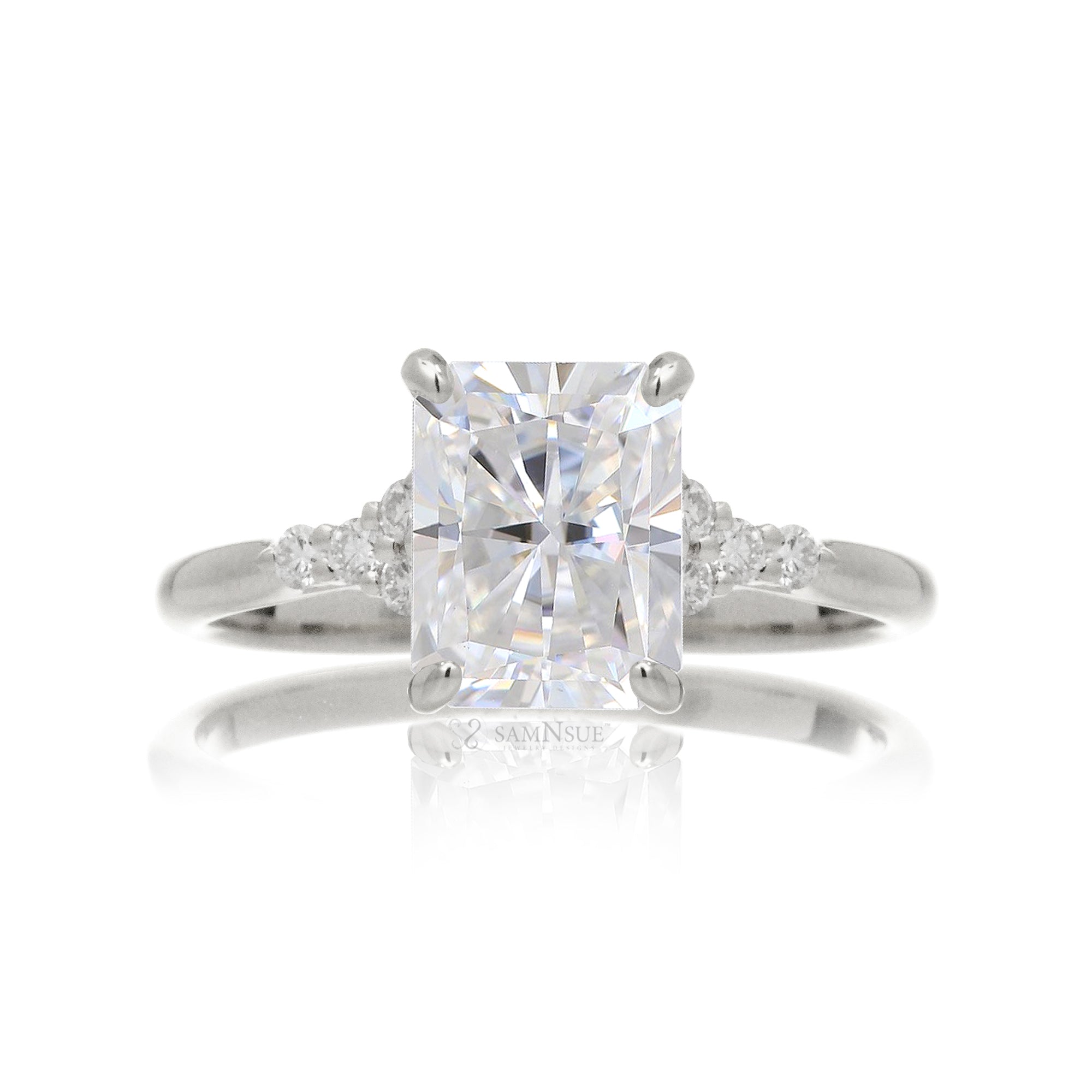 Radiant cut moissanite and diamond three stone ring in white gold