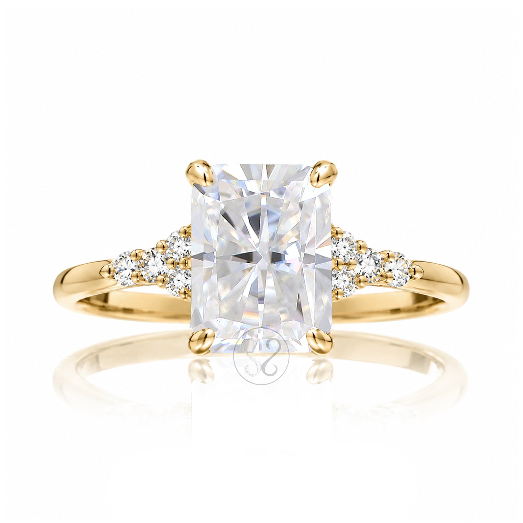 Radiant cut moissanite and diamond three stone ring in yellow gold
