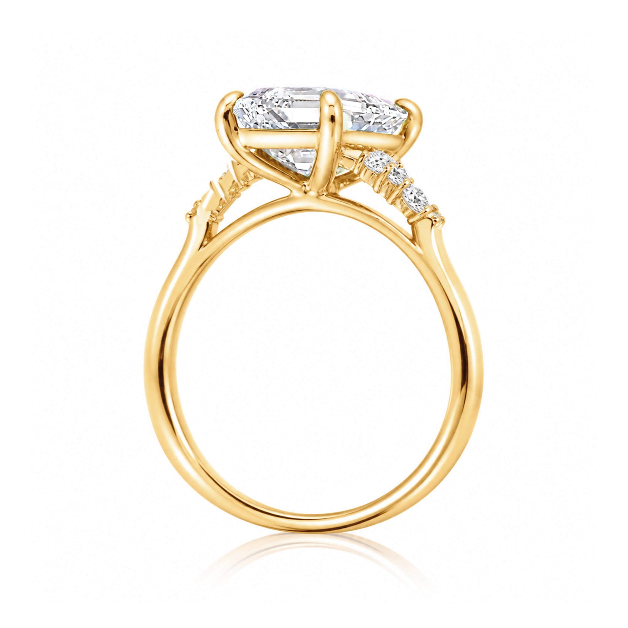 Radiant cut moissanite and diamond three stone ring in yellow gold