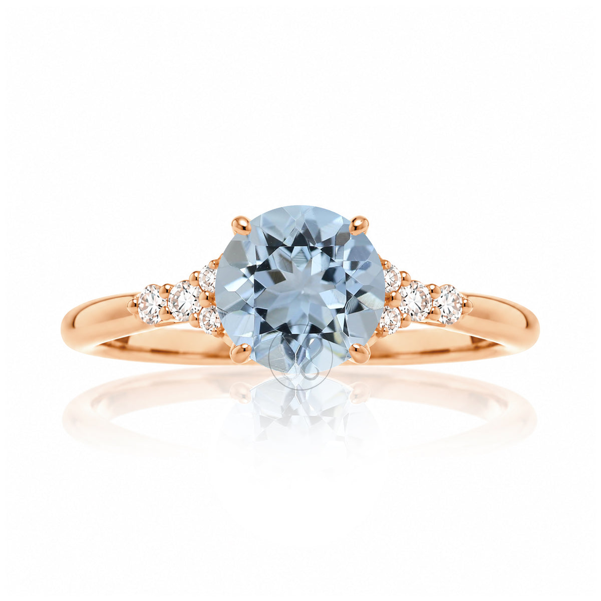 Round aquamarine three stone ring in rose gold