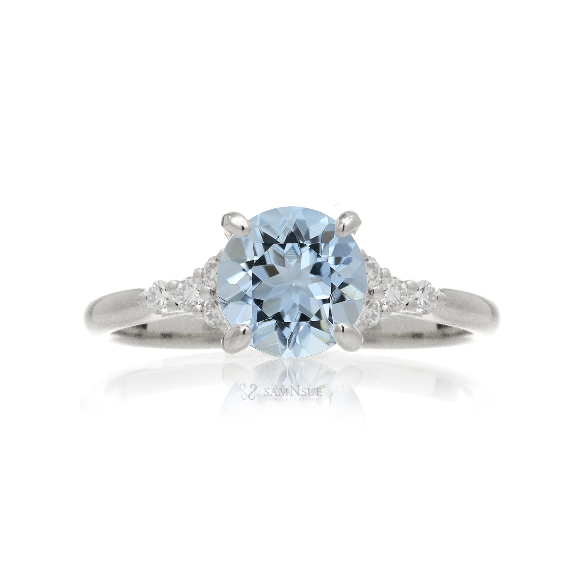 Round aquamarine three stone ring in white gold
