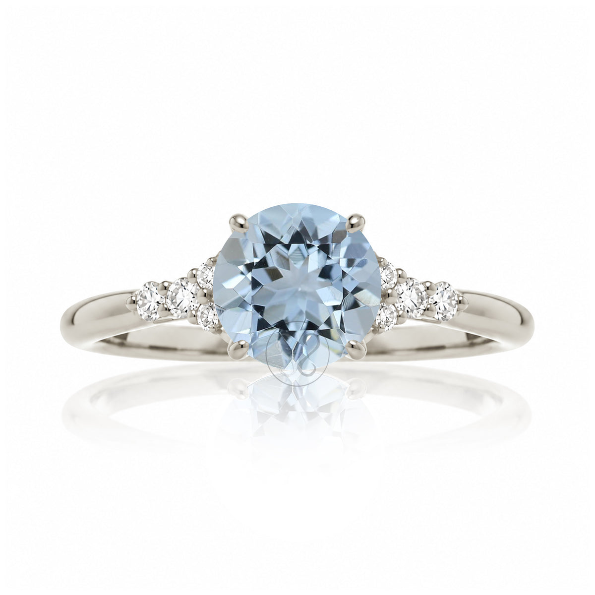 Round aquamarine three stone ring in white gold