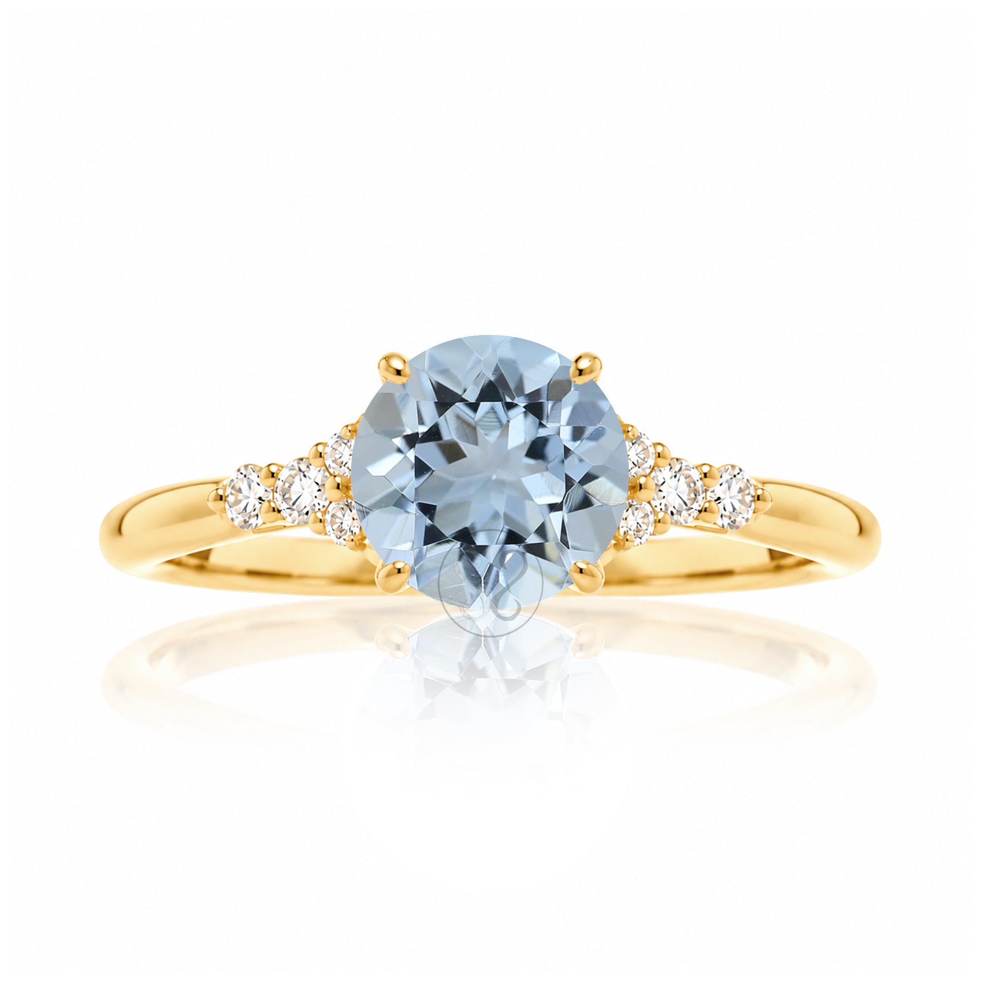 Round aquamarine three stone ring in yellow gold