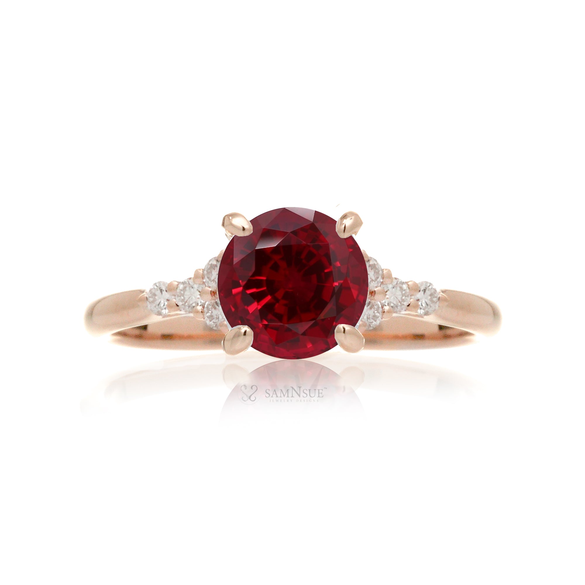 Round cut ruby three stone diamond ring in rose gold