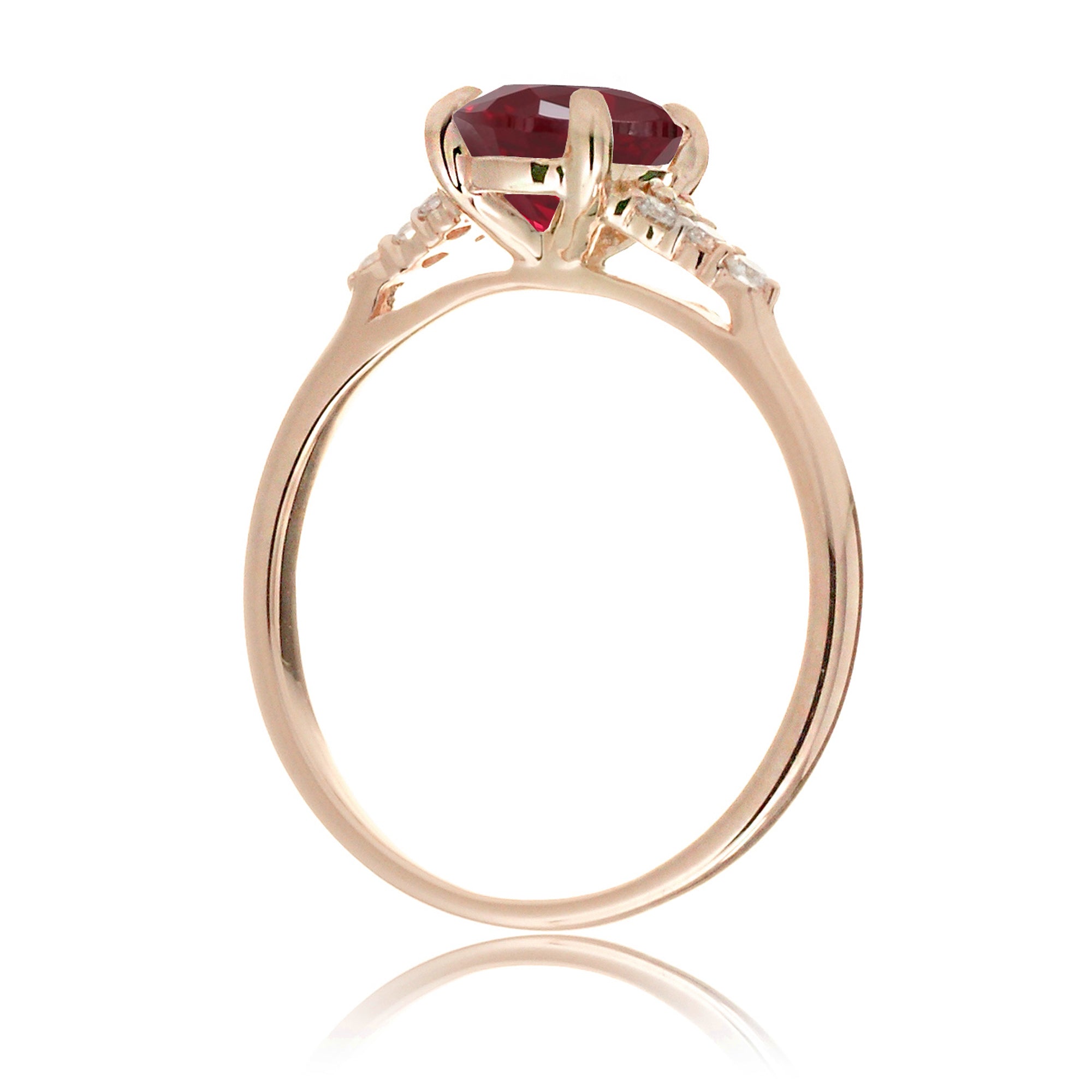 Round cut ruby three stone diamond ring in rose gold