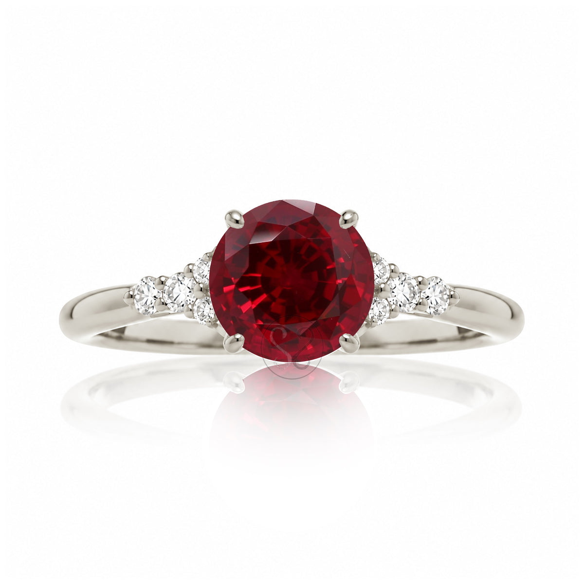 Round cut ruby three stone diamond ring in white gold