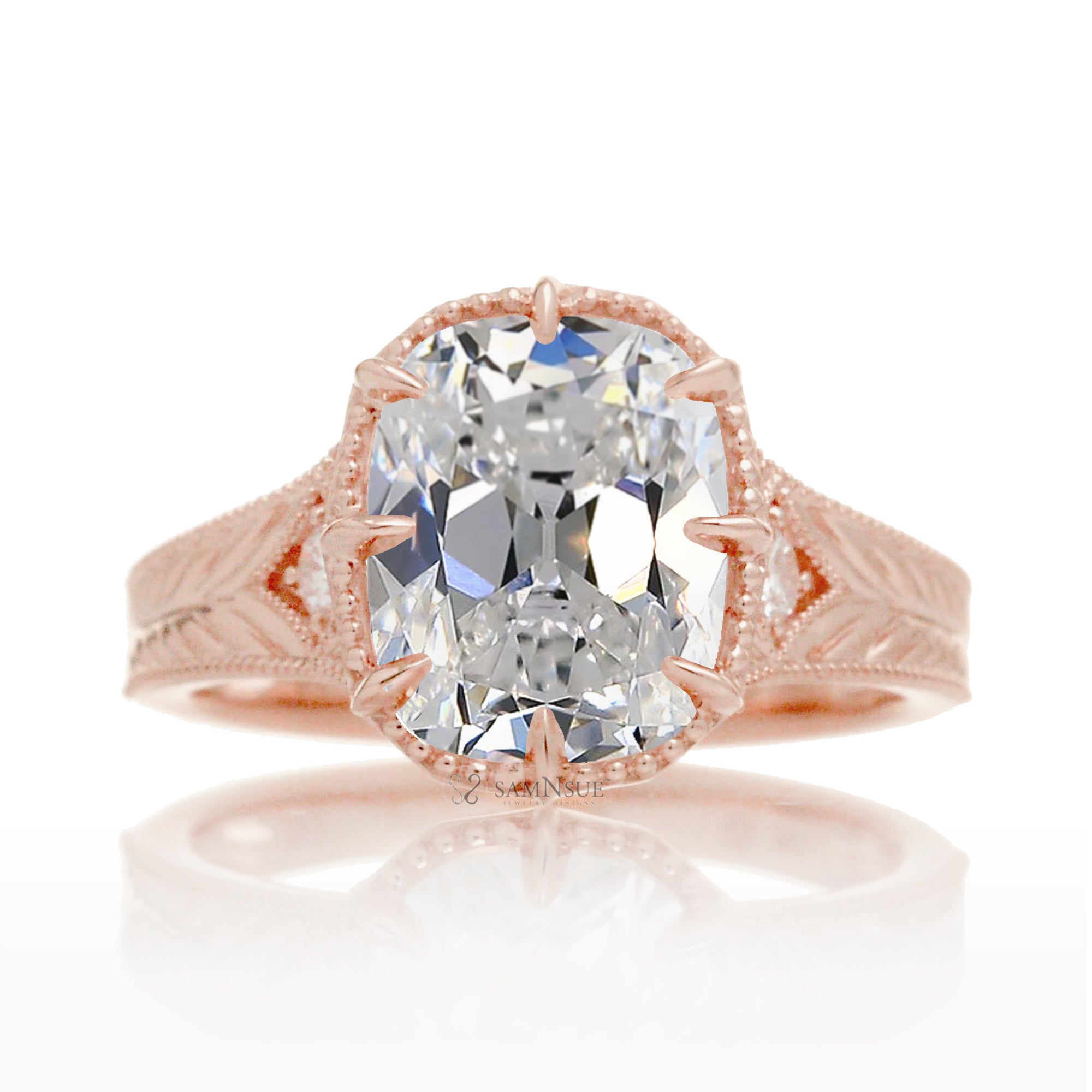 This heirloom-style ring showcases a cushion-shaped diamond with the unique facets of an old mine cut. The warm rose gold setting, paired with intricate engraving, creates a romantic design reminiscent of old-world glamour.