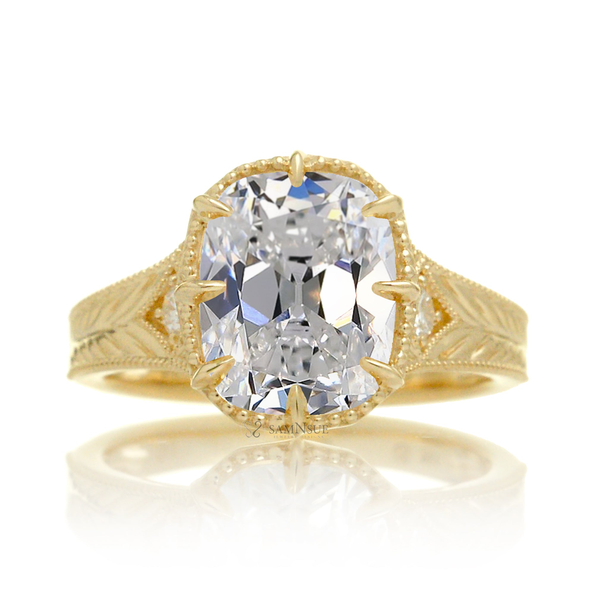 A cushion old mine cut diamond glimmers at the heart of this vintage-inspired engagement ring, set in polished yellow gold. The detailed band features hand-carved artistry, enhancing the antique character and timeless appeal.