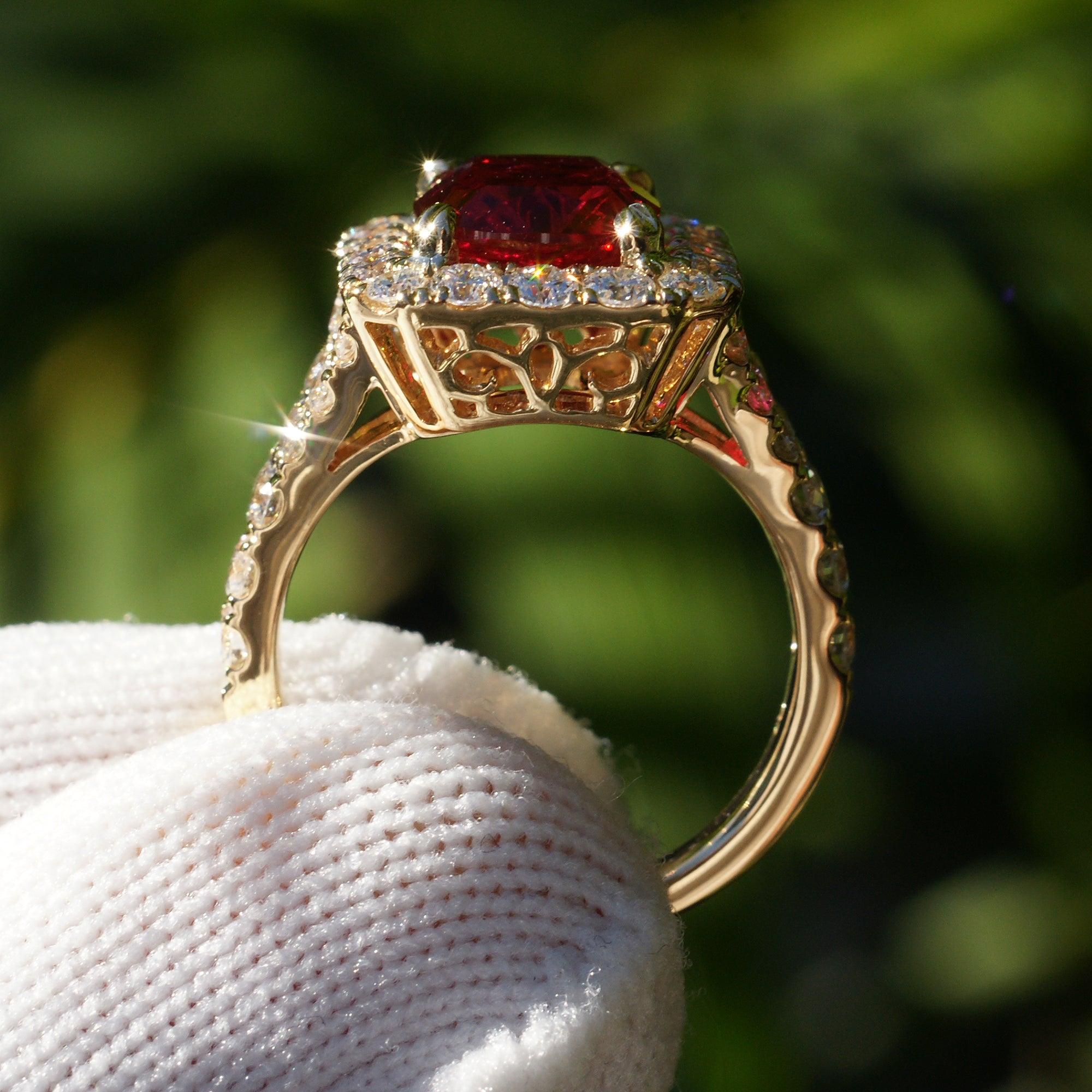 Cushion ruby with large diamond halo engagement ring with split band in yellow gold 10x8mm