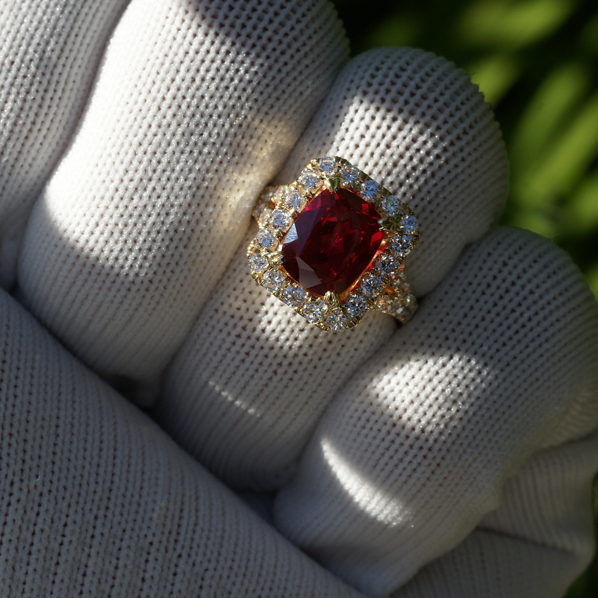 Cushion ruby with large diamond halo engagement ring with split band in yellow gold 10x8mm