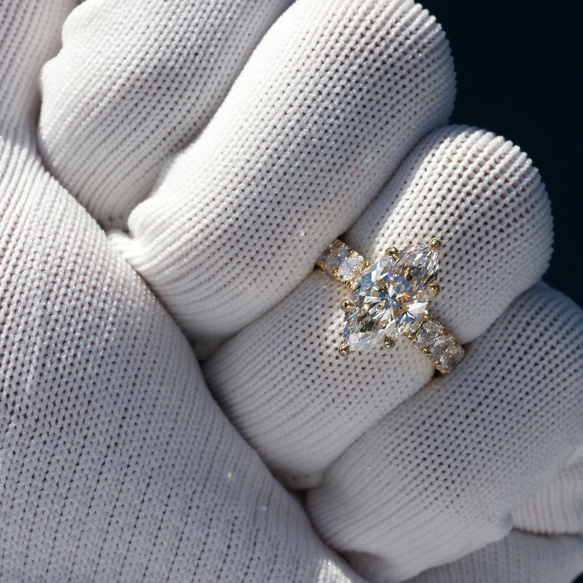 Marquise cut diamond engagement ring with oval diamond band and six prongs yellow gold