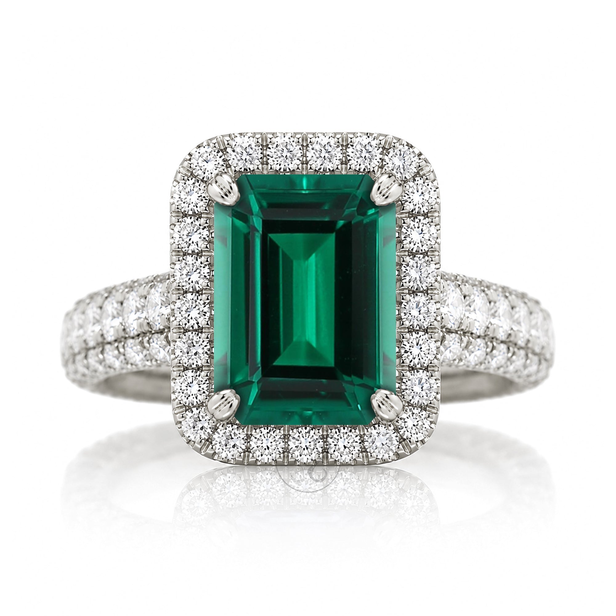 An emerald-cut green gemstone ring with a rose gold halo and diamond-set band three dimensional diamond band thick and bold white gold