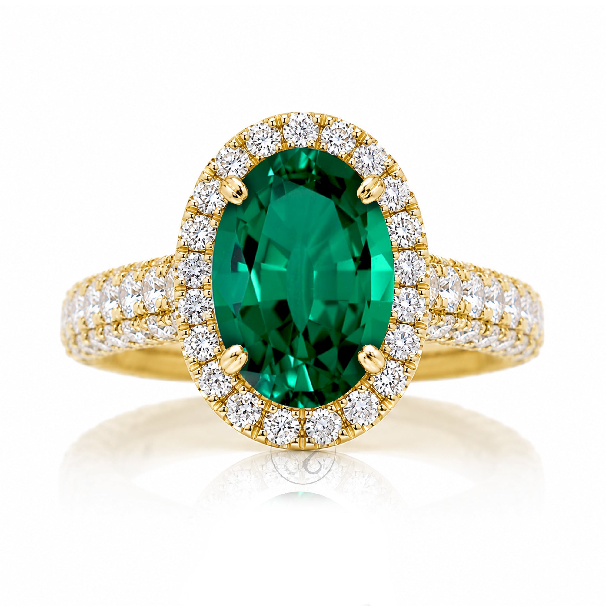 Oval-cut emerald engagement ring in yellow gold with diamond halo and pavé diamond shoulders The Tamara