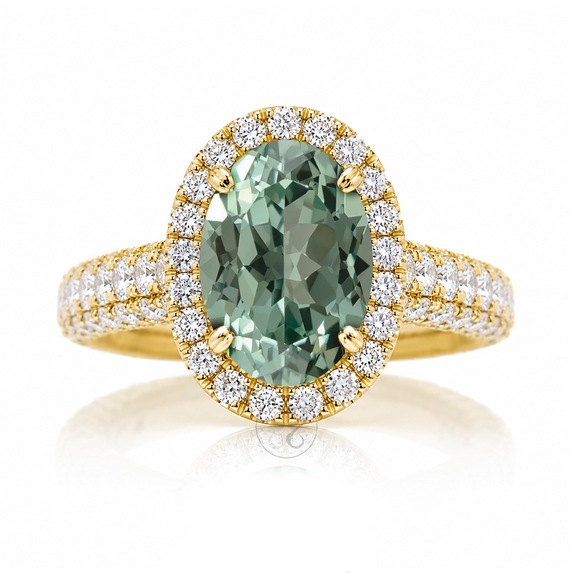 Oval-cut green sapphire engagement ring in yellow gold with diamond halo and pavé diamond shoulders