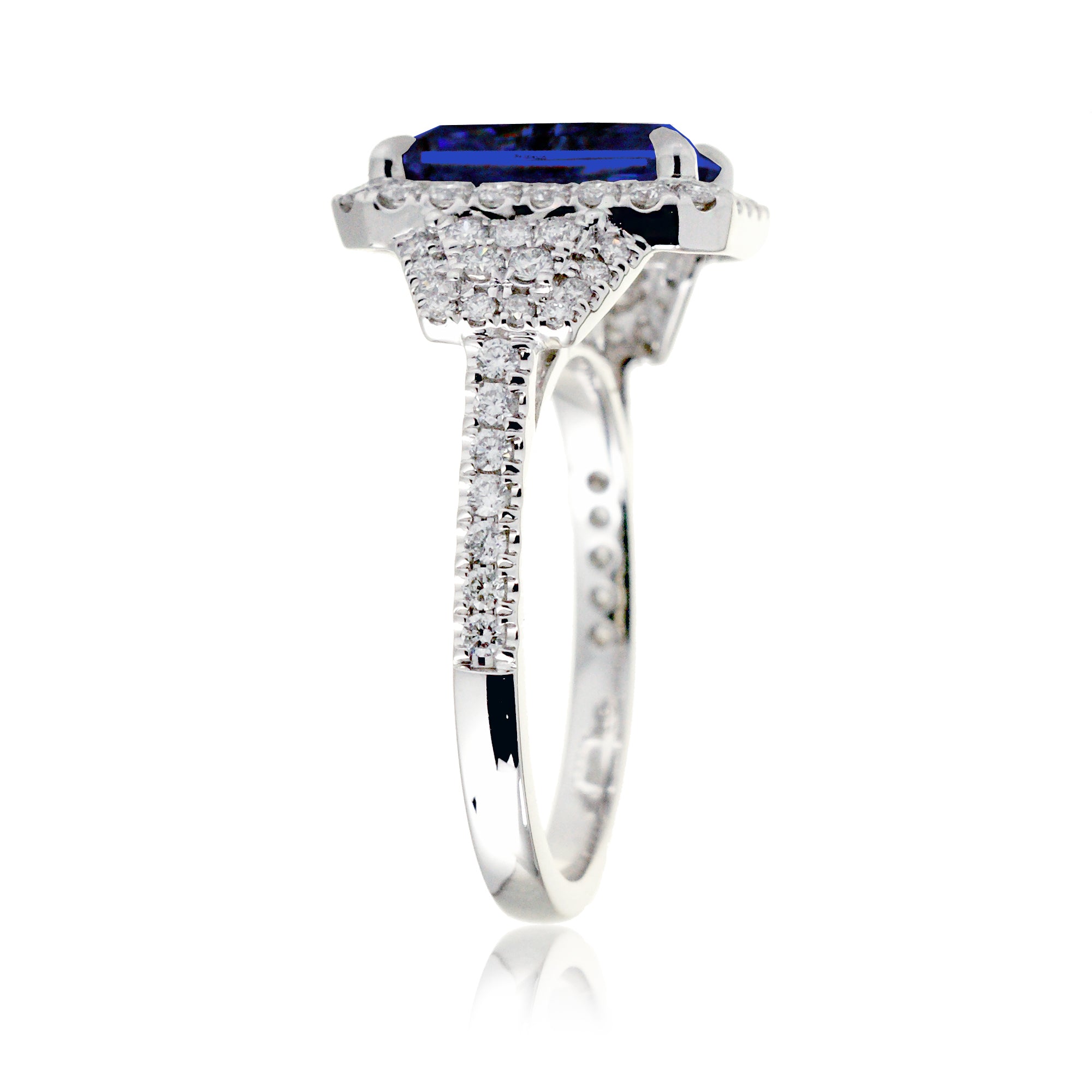 Emerald cut blue sapphire diamond halo and trapezoid three stone ring white gold