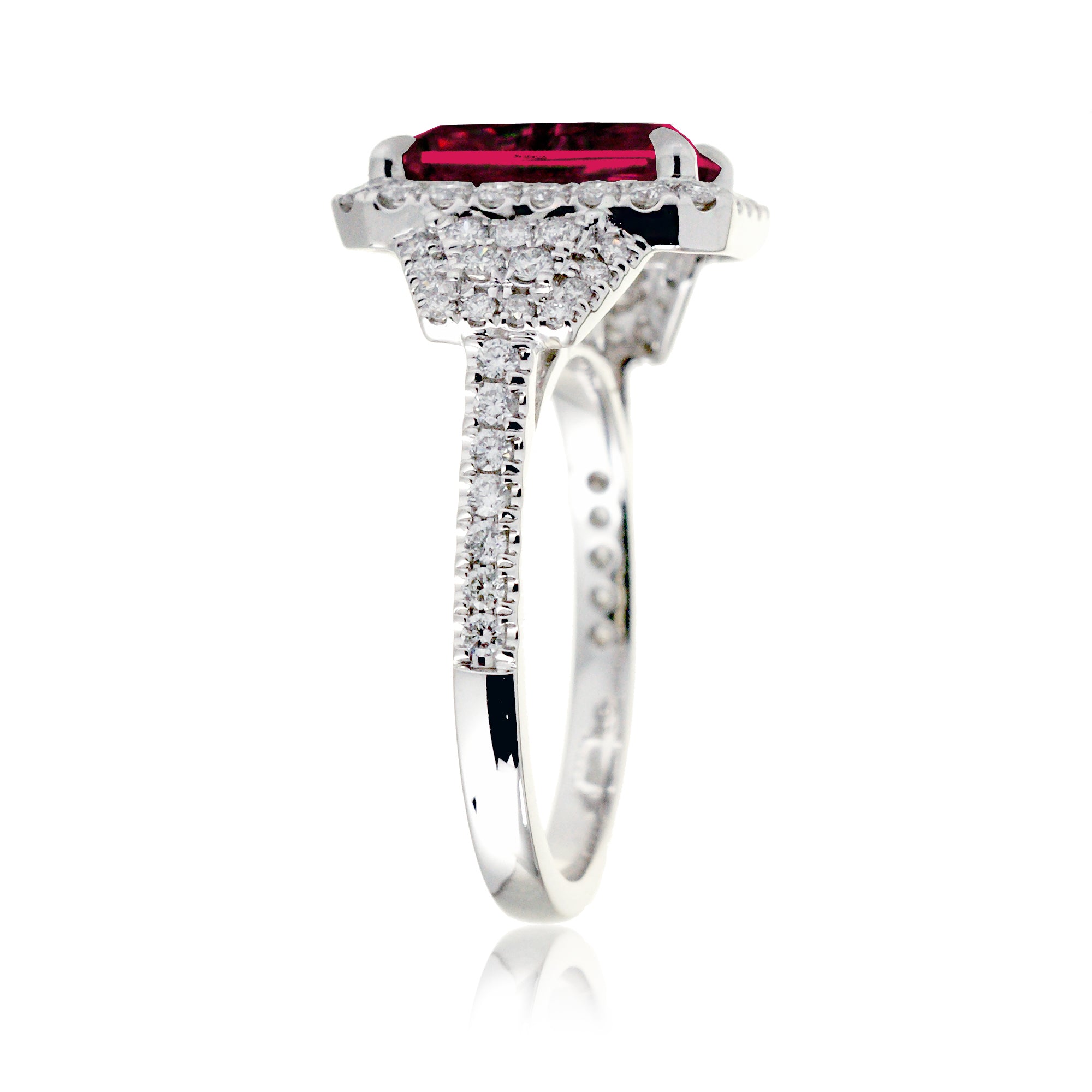 Emerald cut red ruby diamond halo and trapezoid three stone ring white gold
