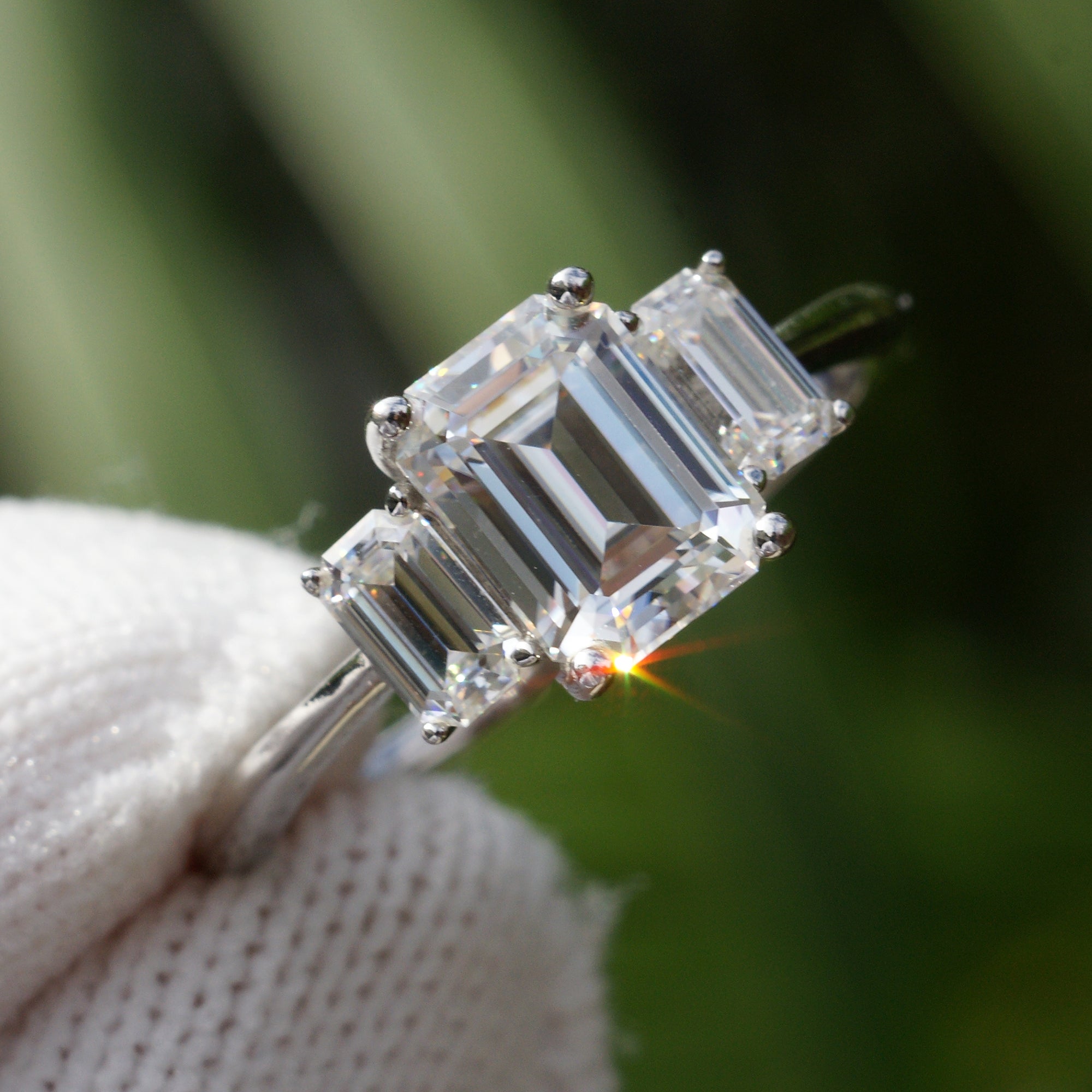 Past present future style moissanite ring in white gold with emerald cut