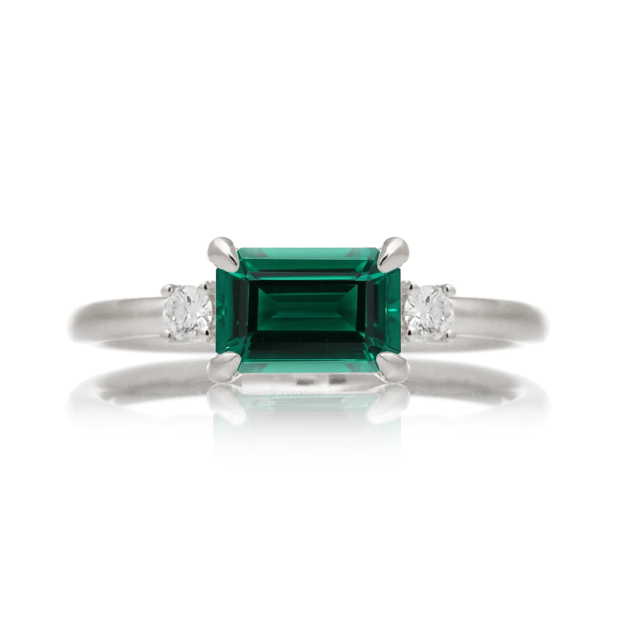 Three Stone side way setting emerald step cut white gold ring