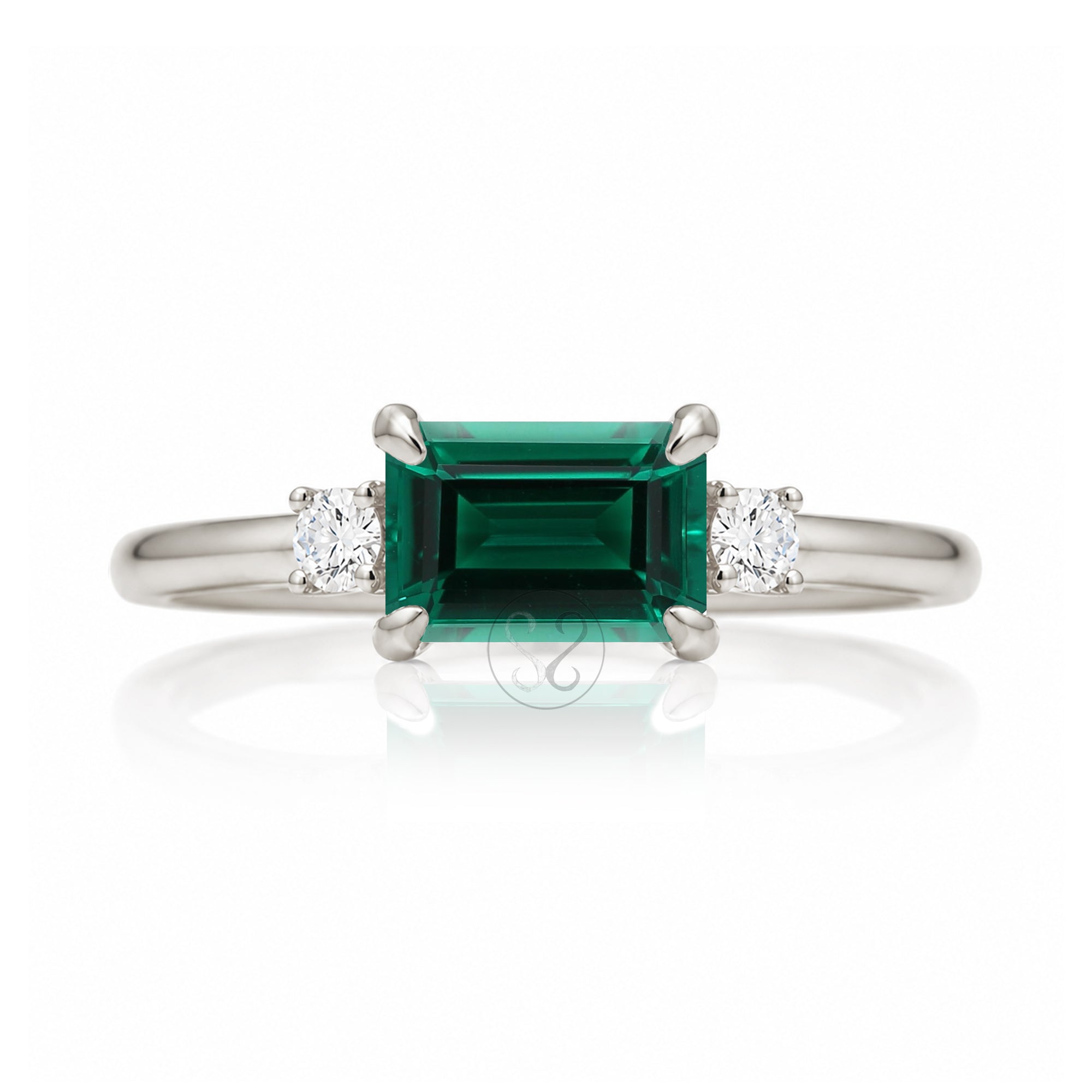 Three Stone side way setting emerald step cut white gold ring