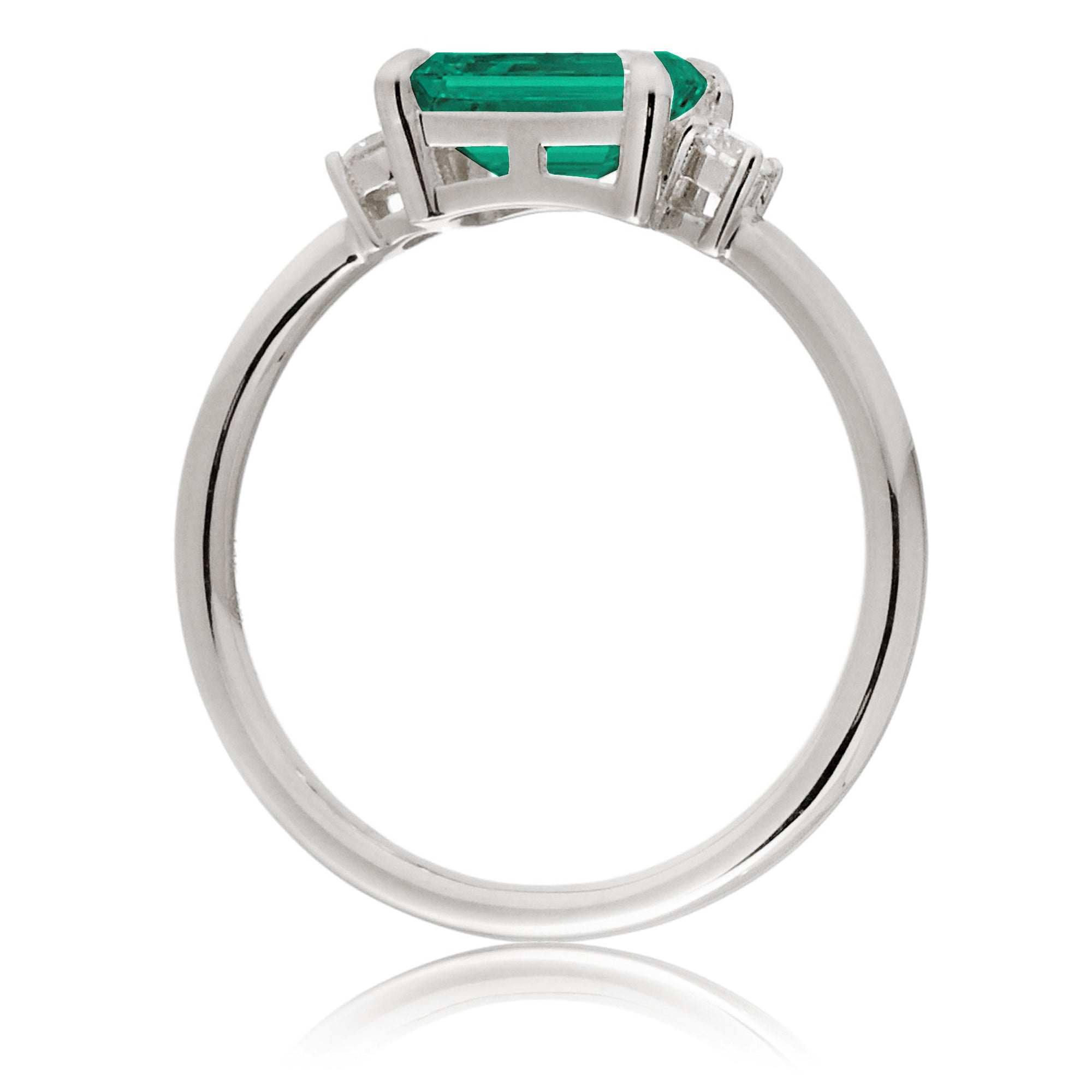 Three Stone side way setting emerald step cut white gold ring