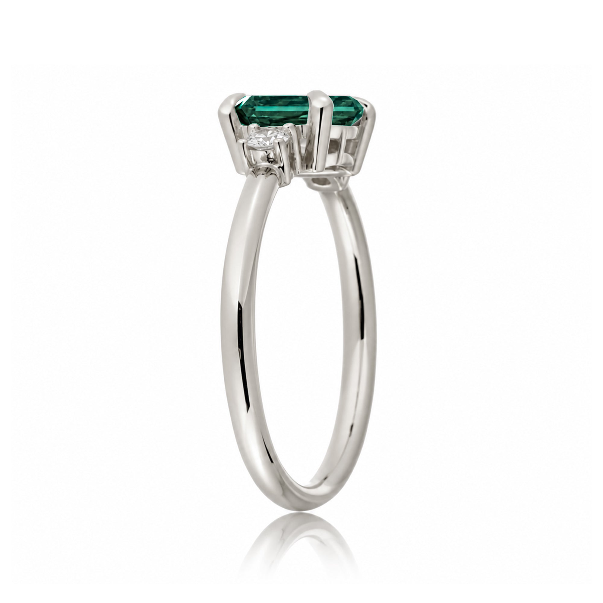 Three Stone side way setting emerald step cut white gold ring