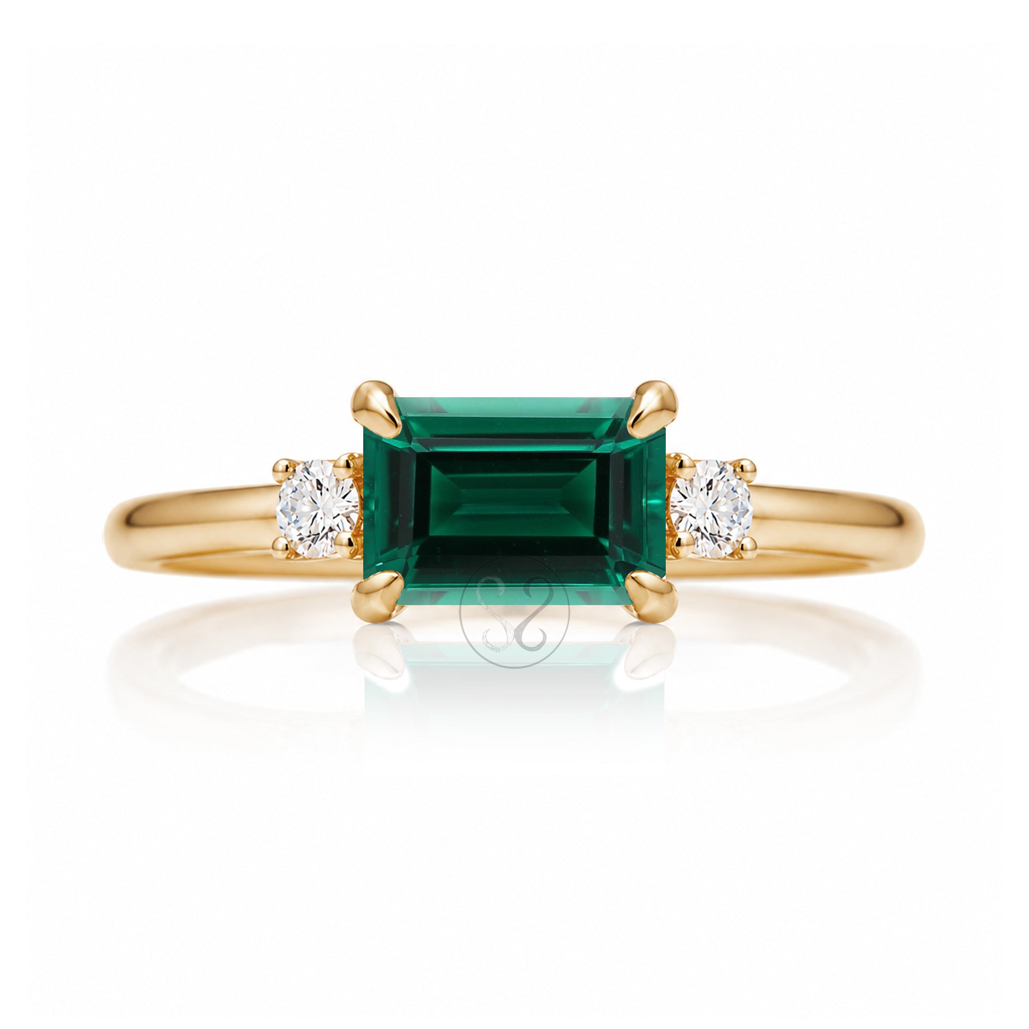 Three Stone side way setting emerald step cut yellow gold ring