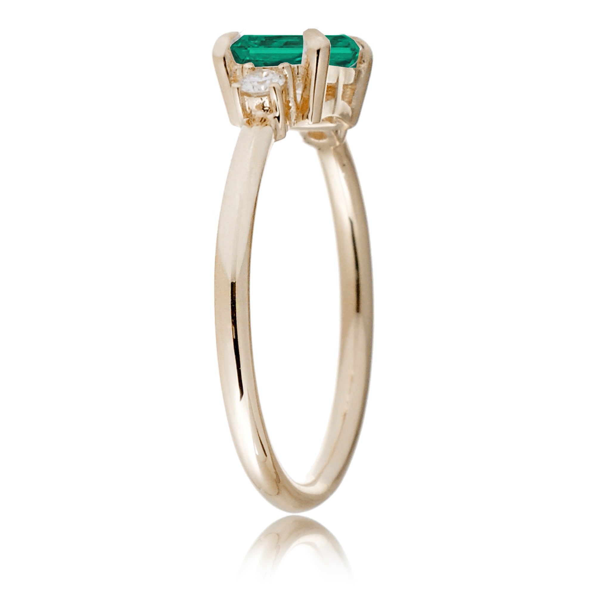 Three Stone side way setting emerald step cut yellow gold ring