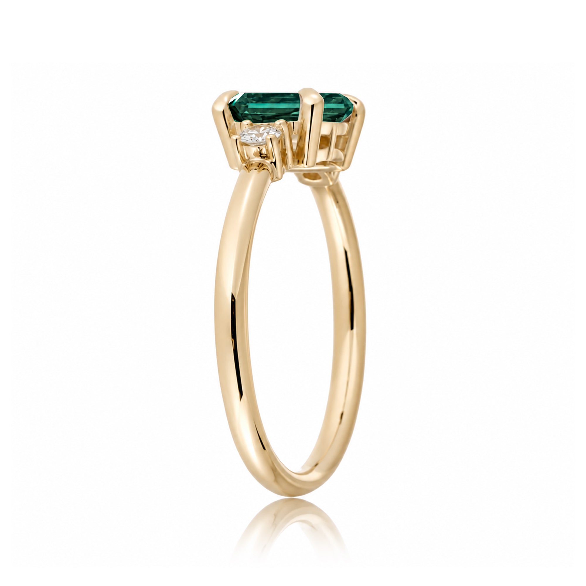 Three Stone side way setting emerald step cut yellow gold ring