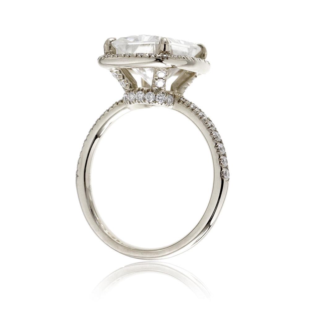 Emerald cut moissanite engagement ring with diamond halo the Drenched white gold profile view