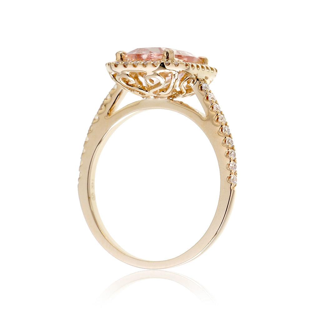 Cushion cut morganite ring with a diamond halo in yellow gold