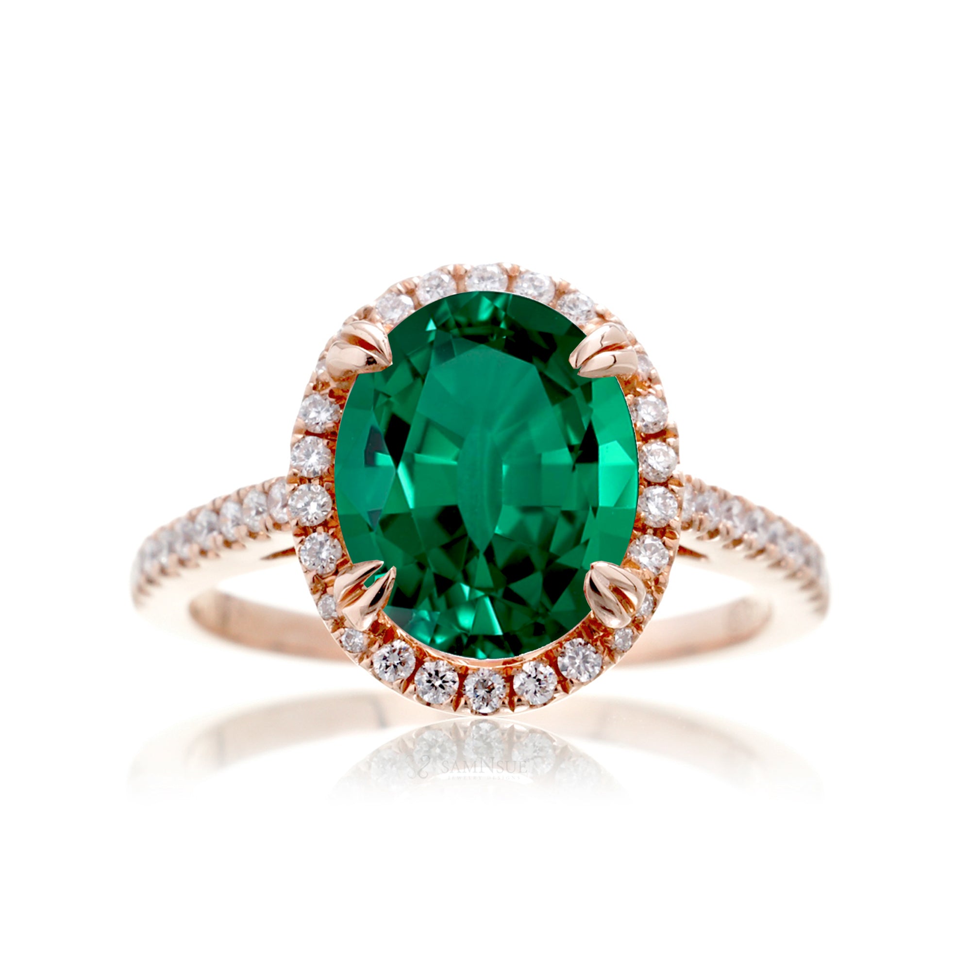 Oval cut green emerald engagement ring with a diamond halo in rose gold