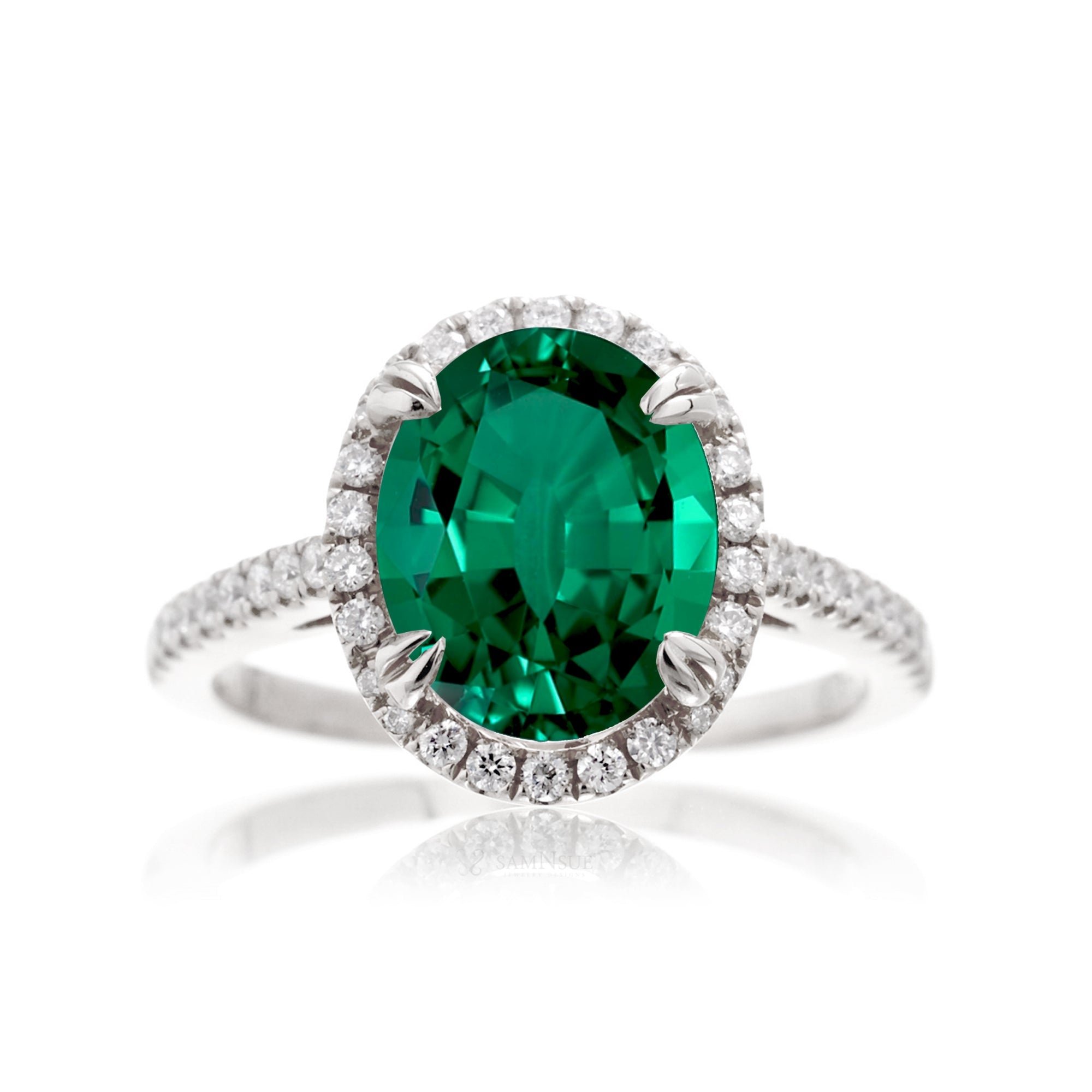 Oval cut green emerald engagement ring with a diamond halo in white gold