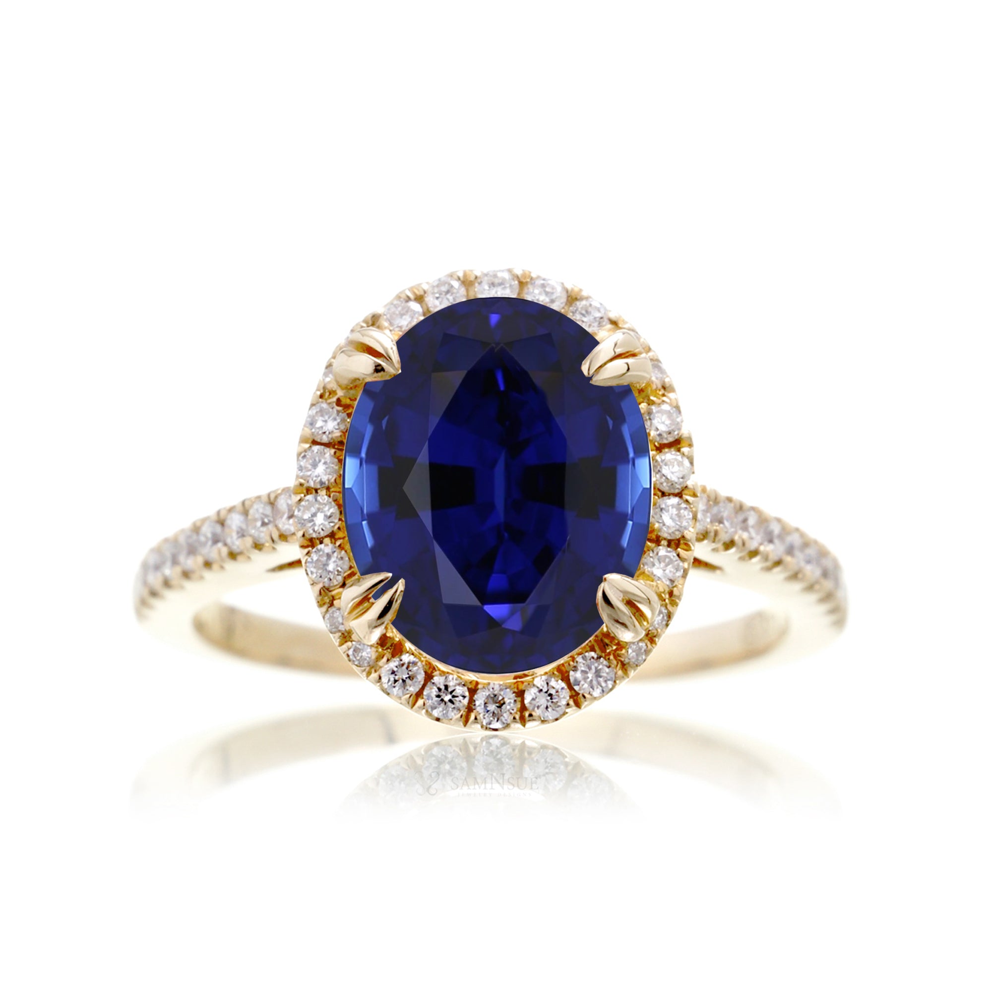Oval shape blue sapphire ring with diamond halo in yellow gold