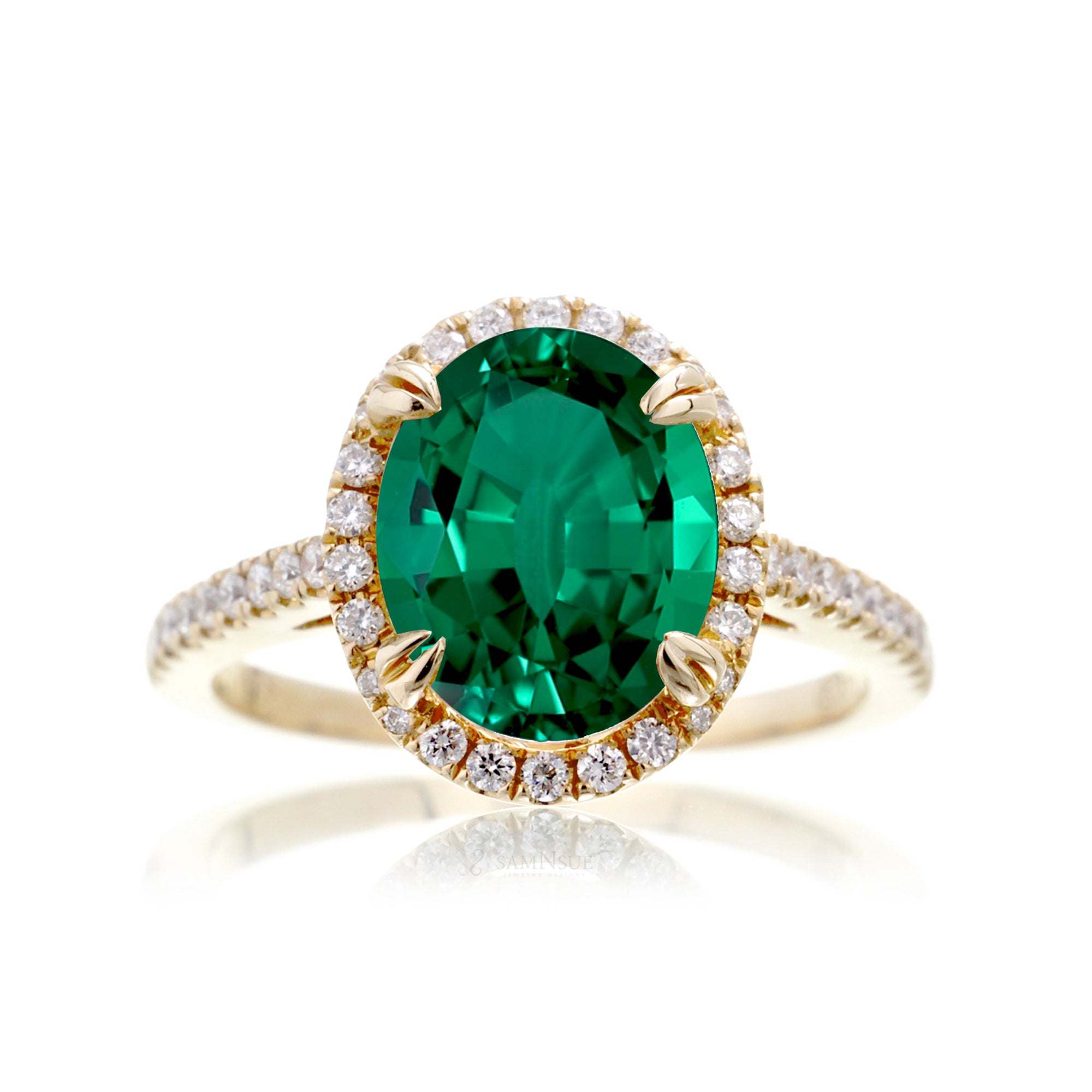 Oval cut green emerald engagement ring with a diamond halo in yellow gold