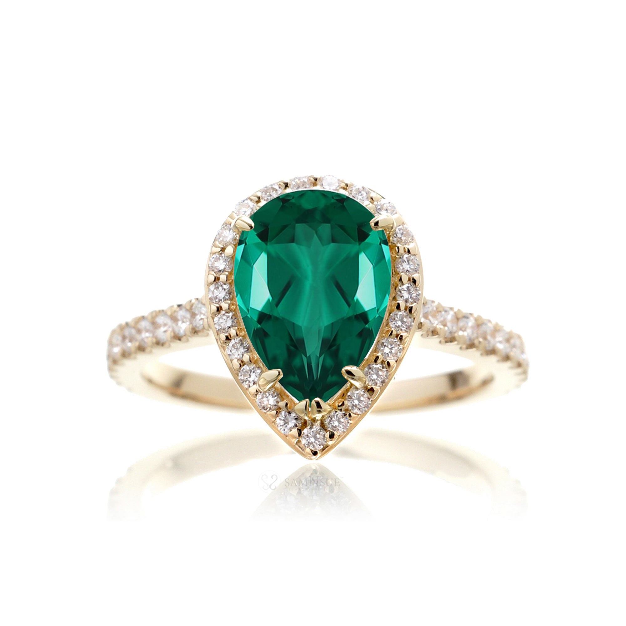 Pear emerald with diamond halo and band hidden bezel in yellow gold
