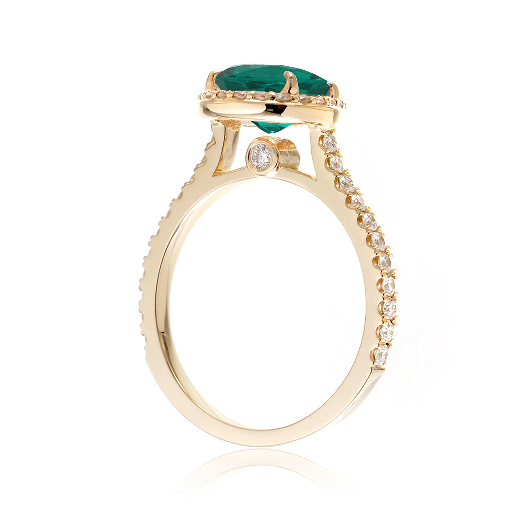 Pear emerald with diamond halo and band hidden bezel in yellow gold