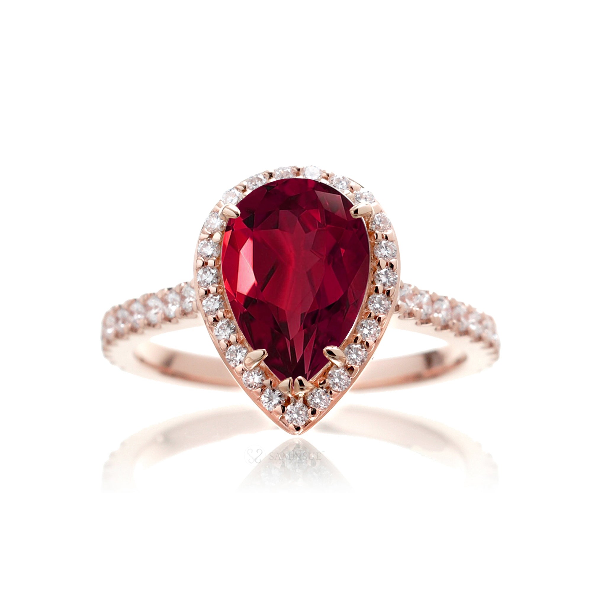 Pear ruby engagement ring with diamond halo and diamond band rose gold