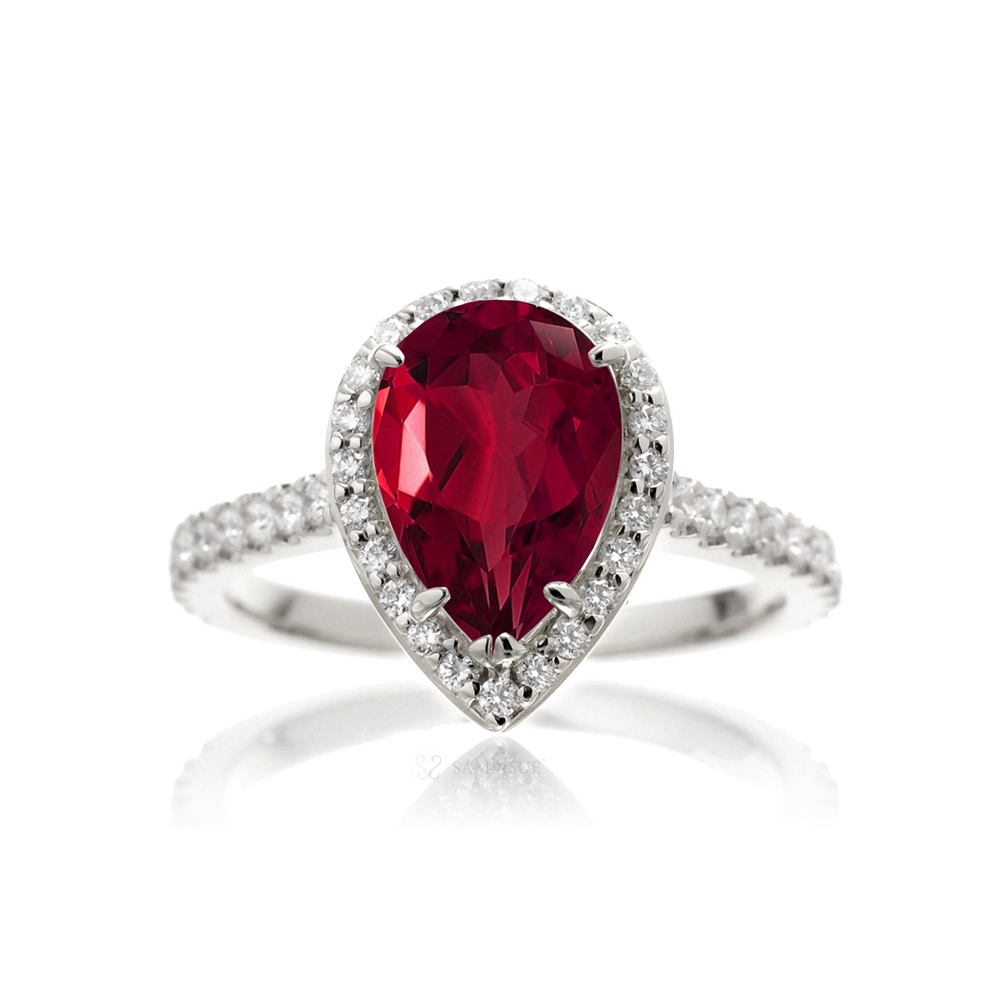 Pear ruby engagement ring with diamond halo and diamond band white gold