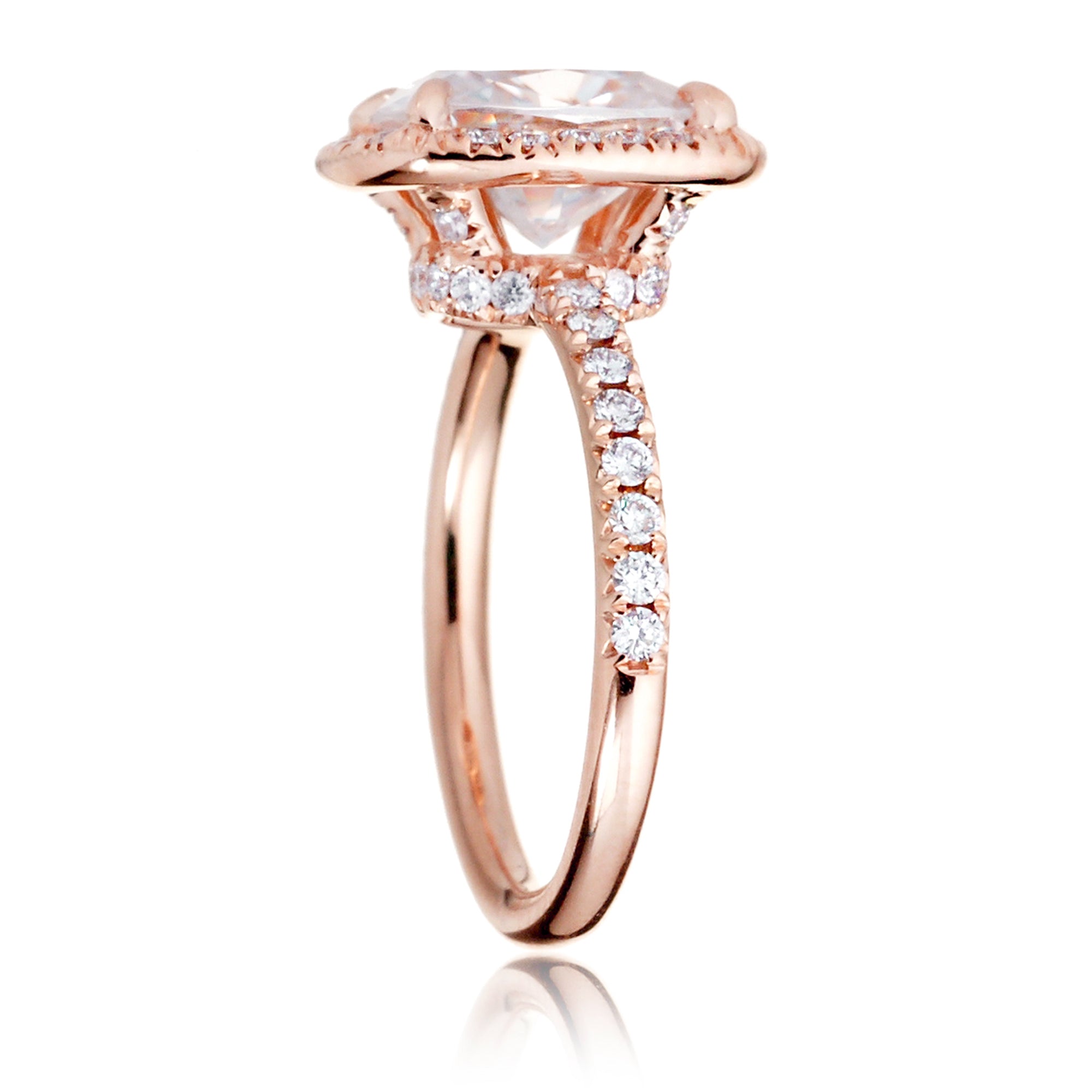Cushion moissanite and diamond halo ring with a diamond band in rose gold - the drenched