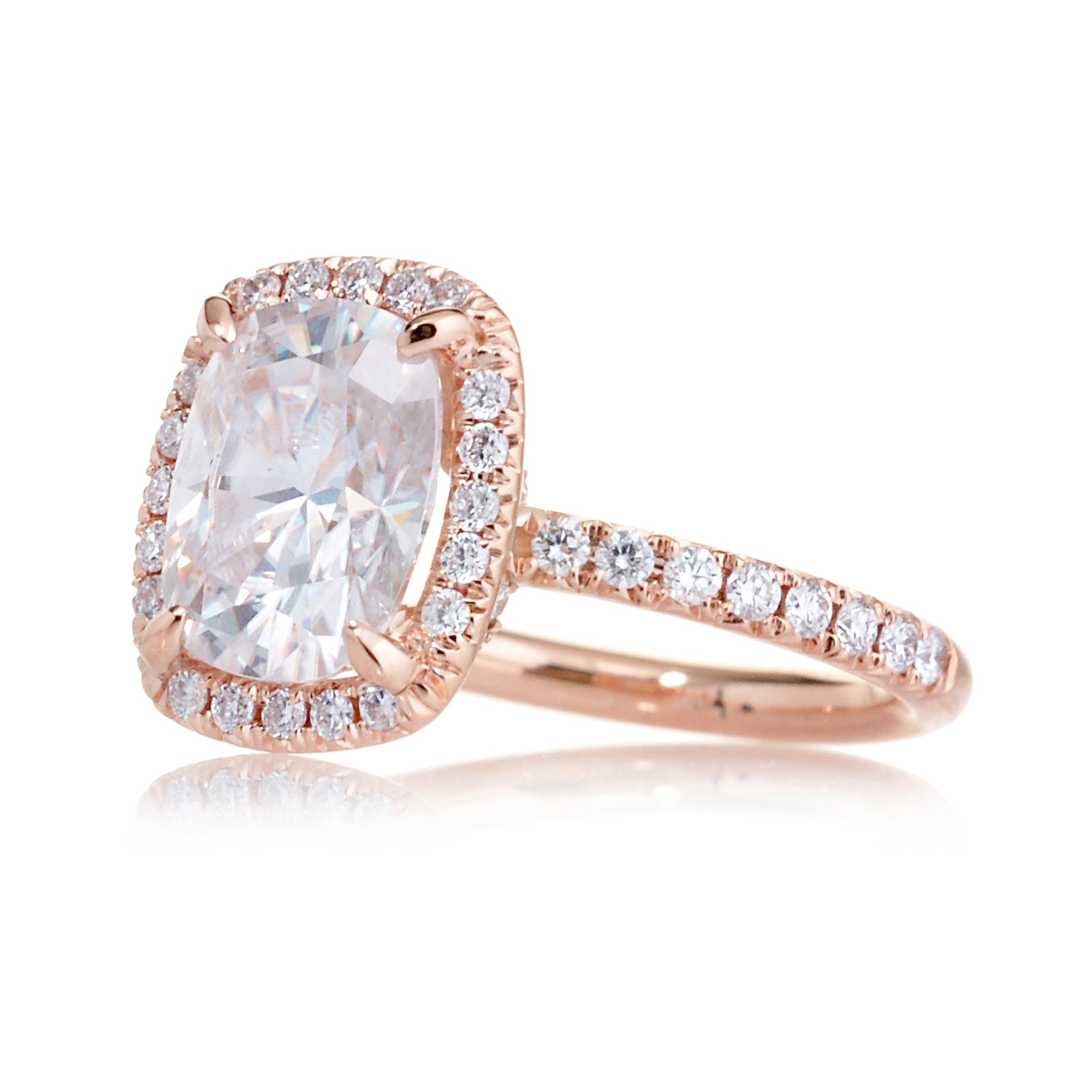 Cushion moissanite and diamond halo ring with a diamond band in rose gold - the drenched