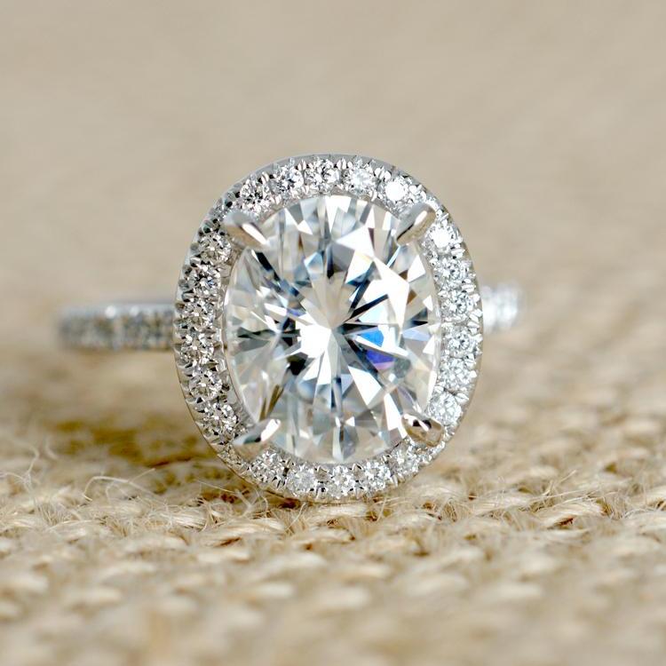 Oval moissanite cut engagement ring with diamond halo the Drenched white gold