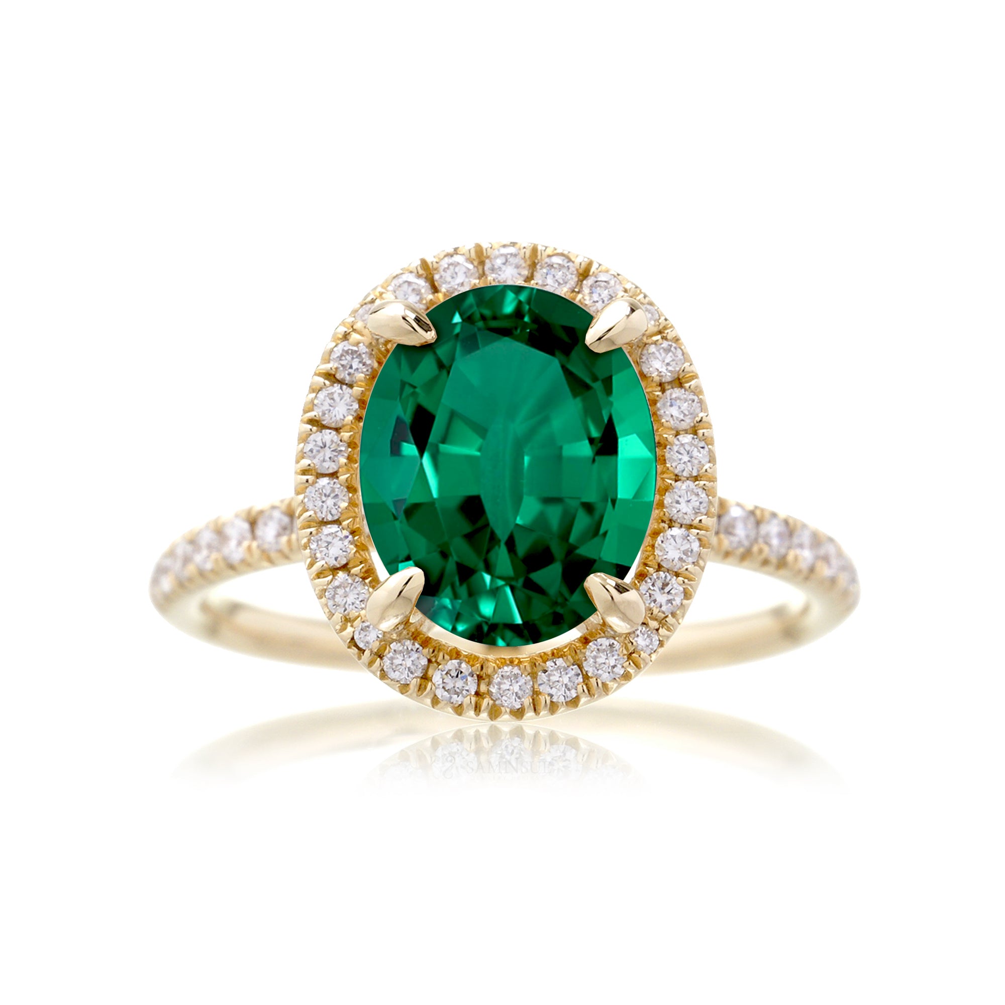 Oval cut emerald engagement ring with diamond halo the Drenched yellow gold