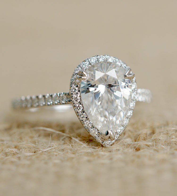 Pear moissanite ring with diamond halo in white gold